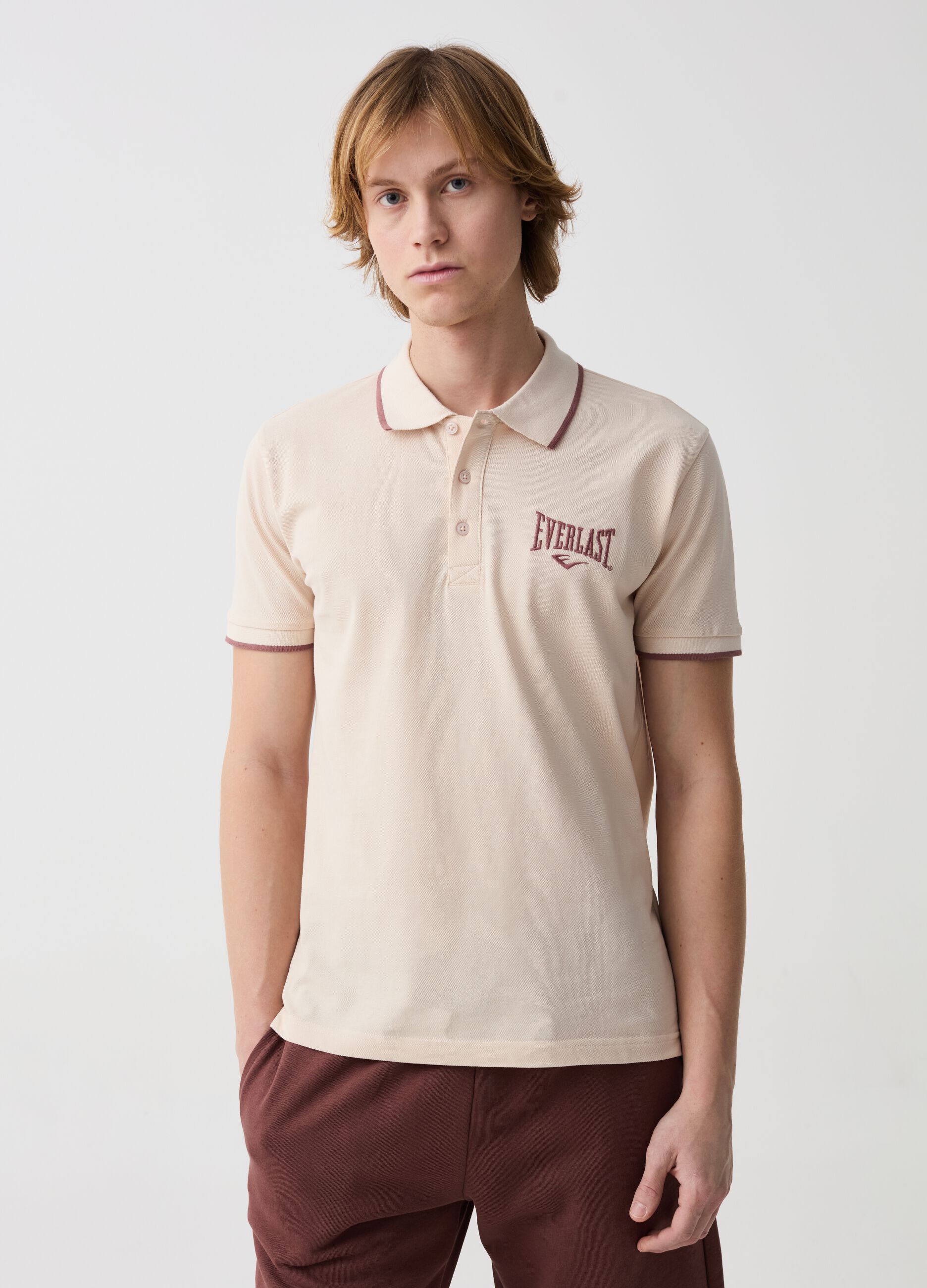 Polo shirt with striped edging and logo embroidery