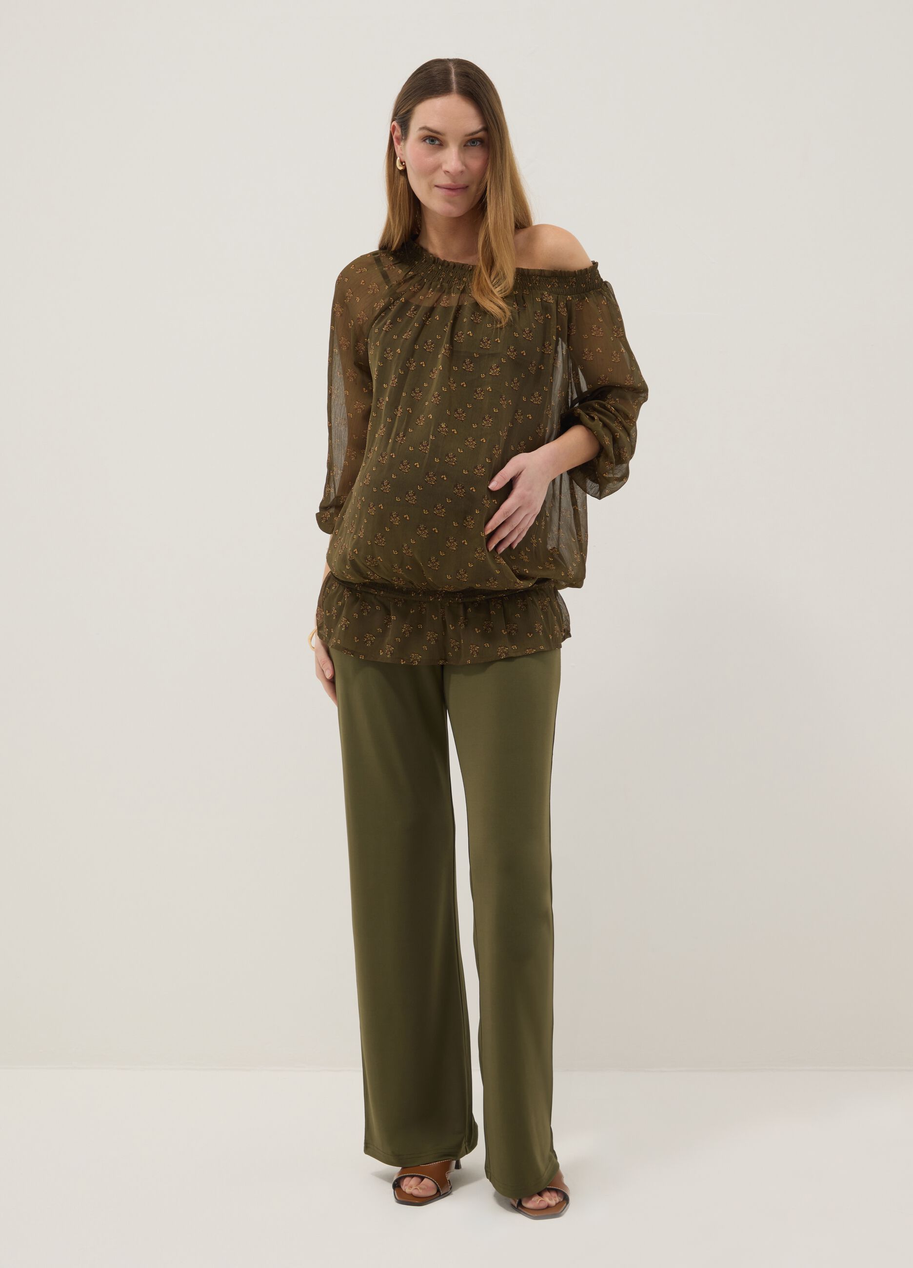 Green maternity blouse with boat neckline and fantasy print