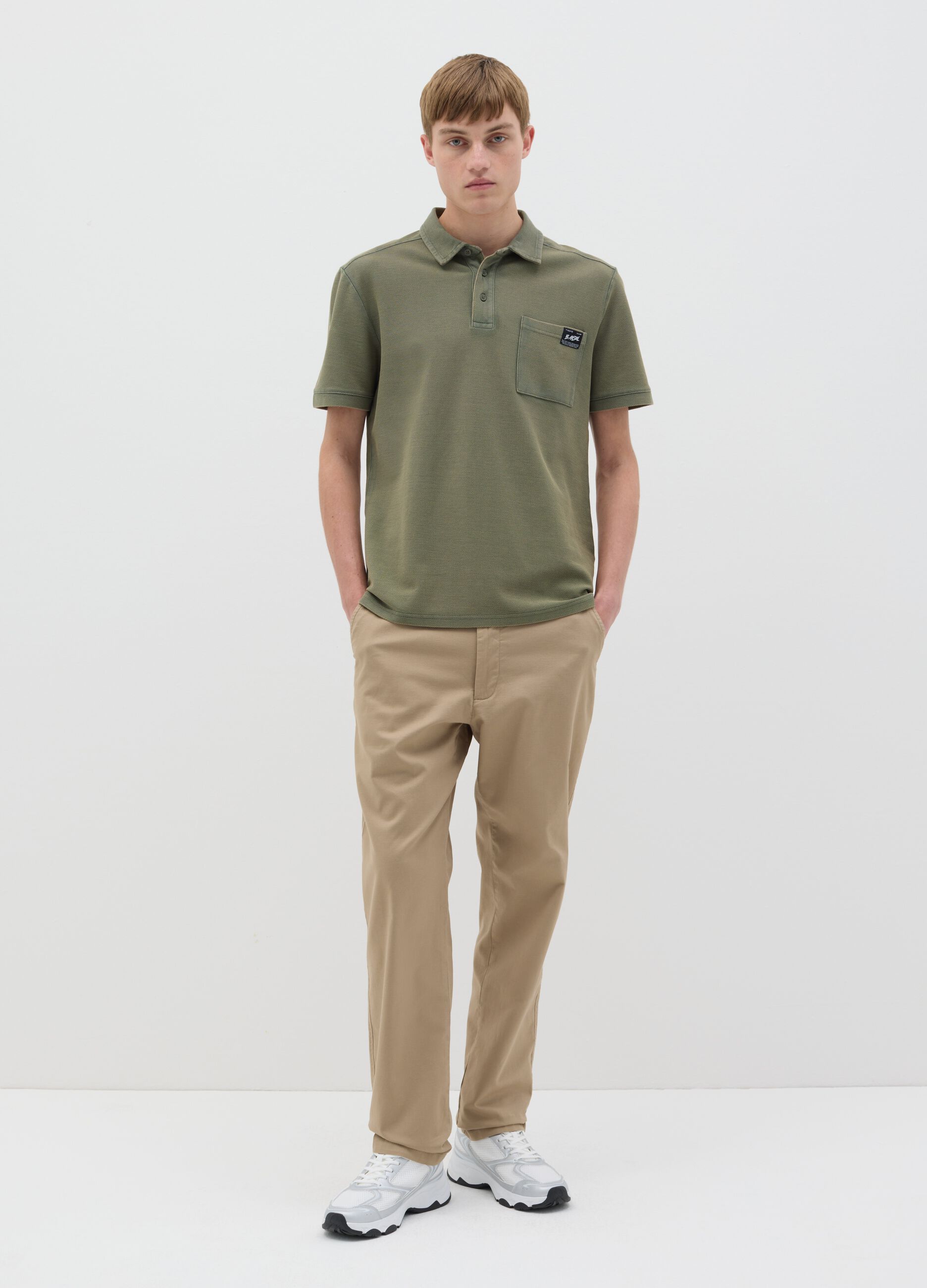 Green short-sleeved polo shirt in cotton piquet