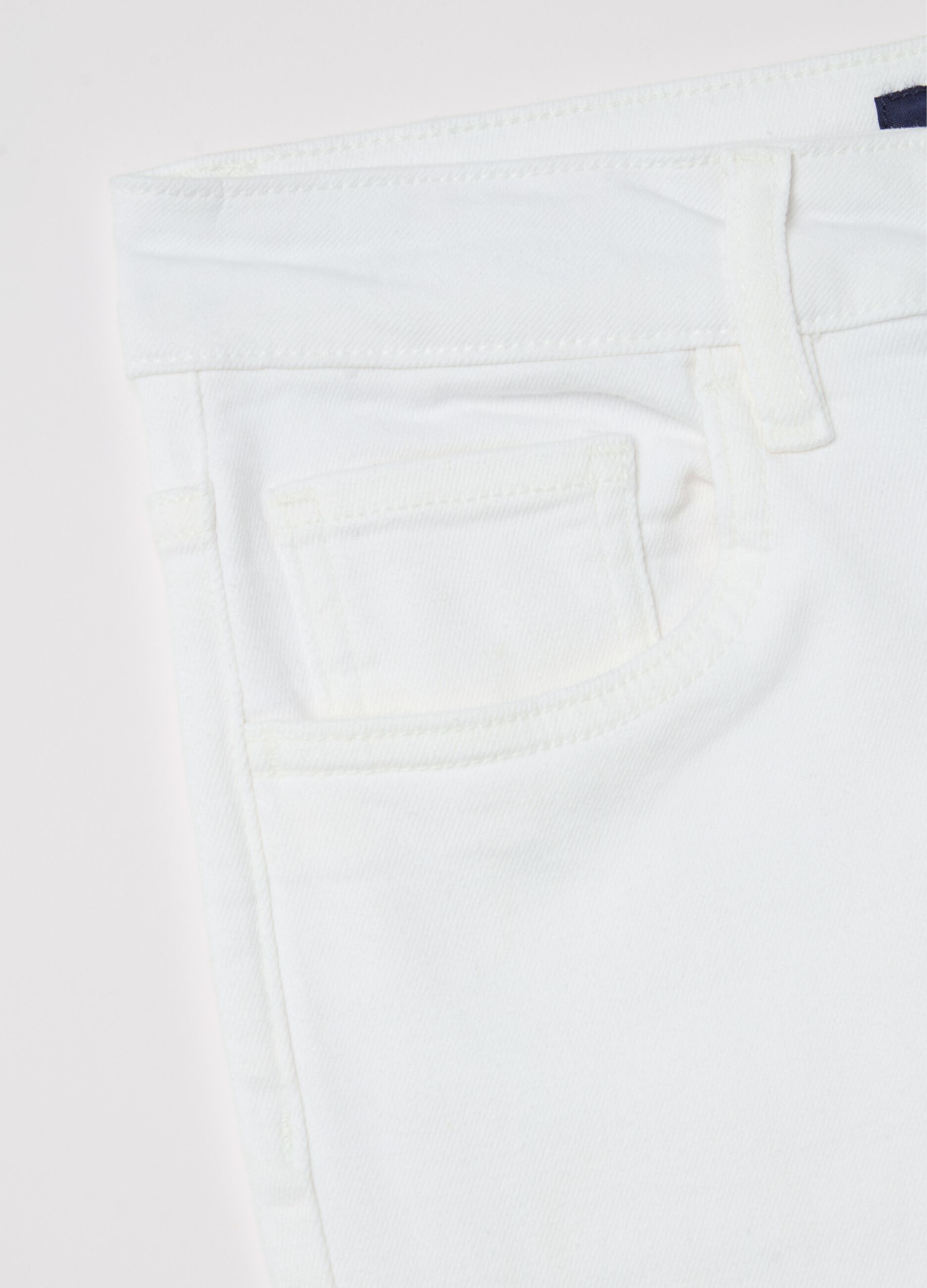 Cropped white flare-fit jeans with raw edging