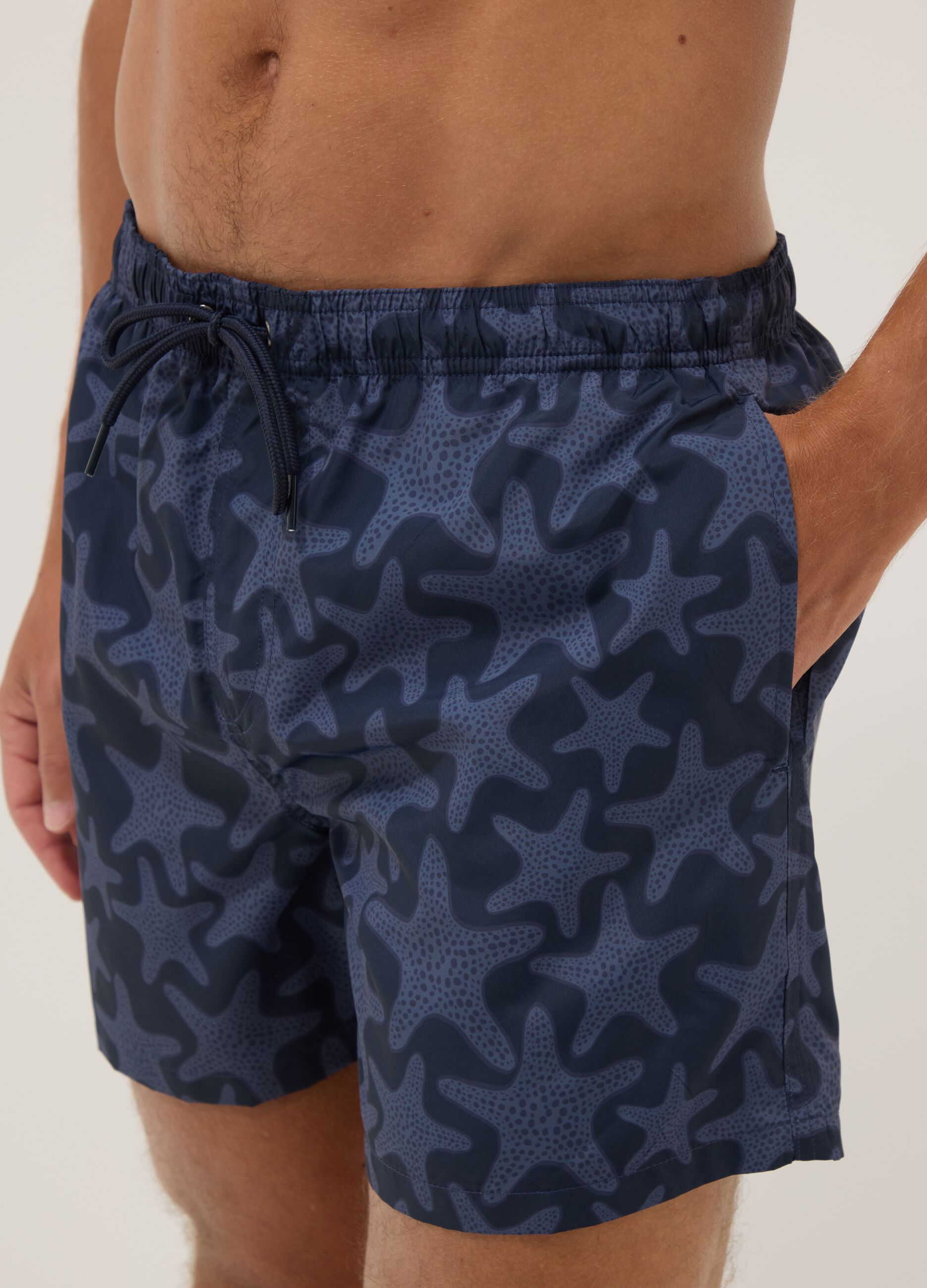 Blue swim shorts with starfish print