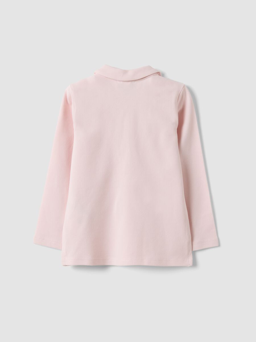 Polo rosa in cotone organico elasticizzato con dettagli volant per bimba_1