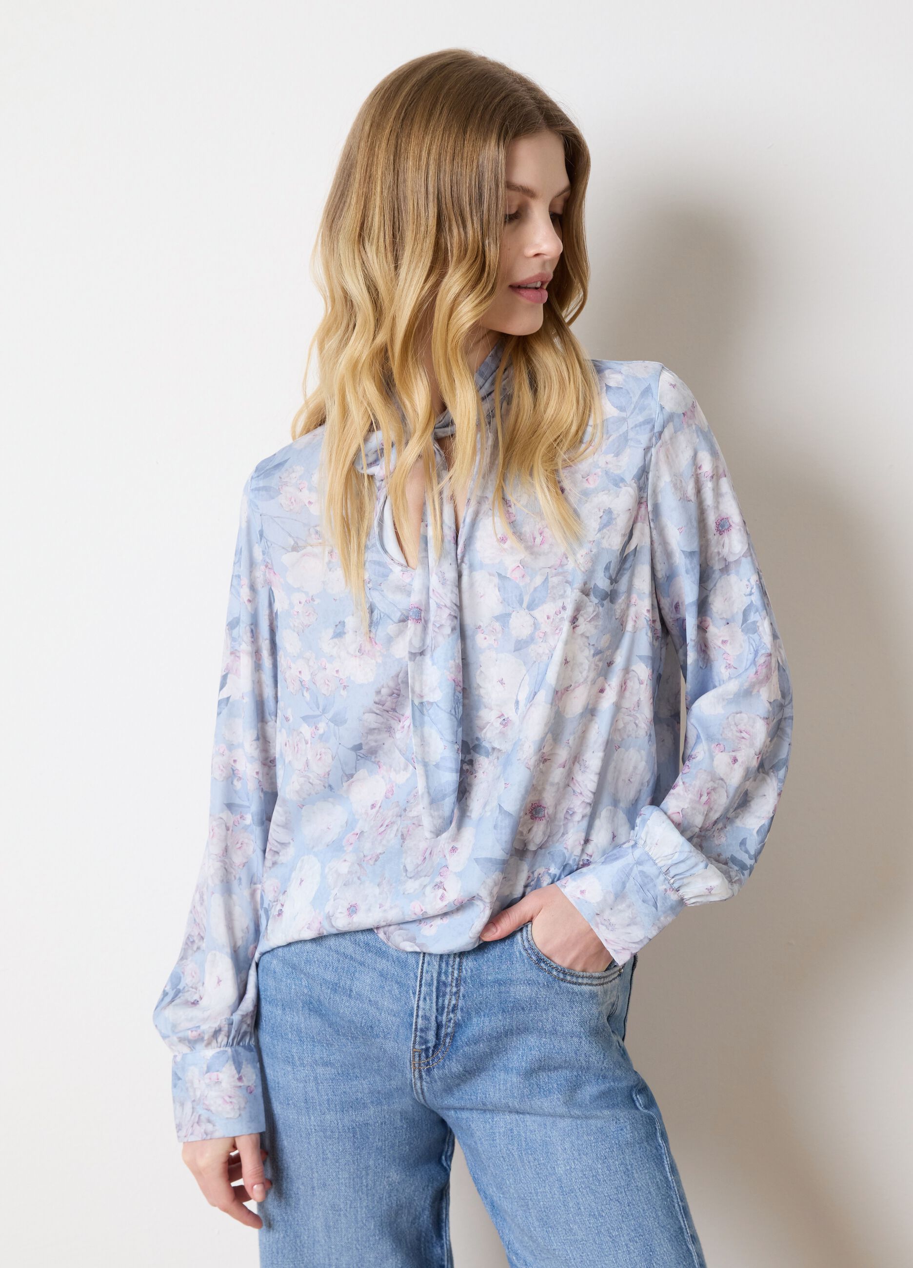 Light blue blouse with floral pattern and bow