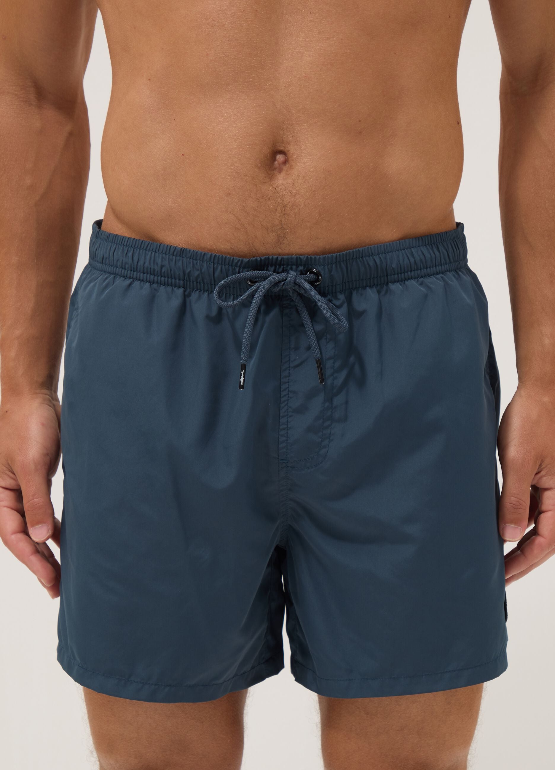 Blue swim shorts with elasticated waistband and drawstring