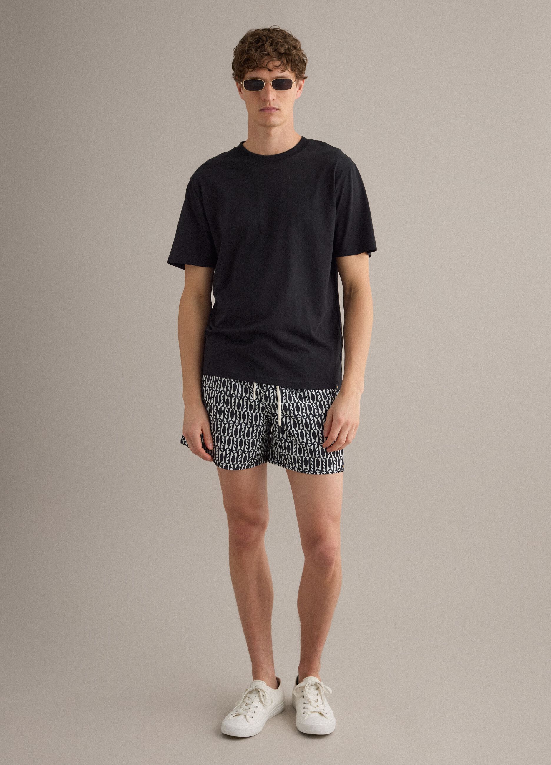 Blue swim shorts with graphic print