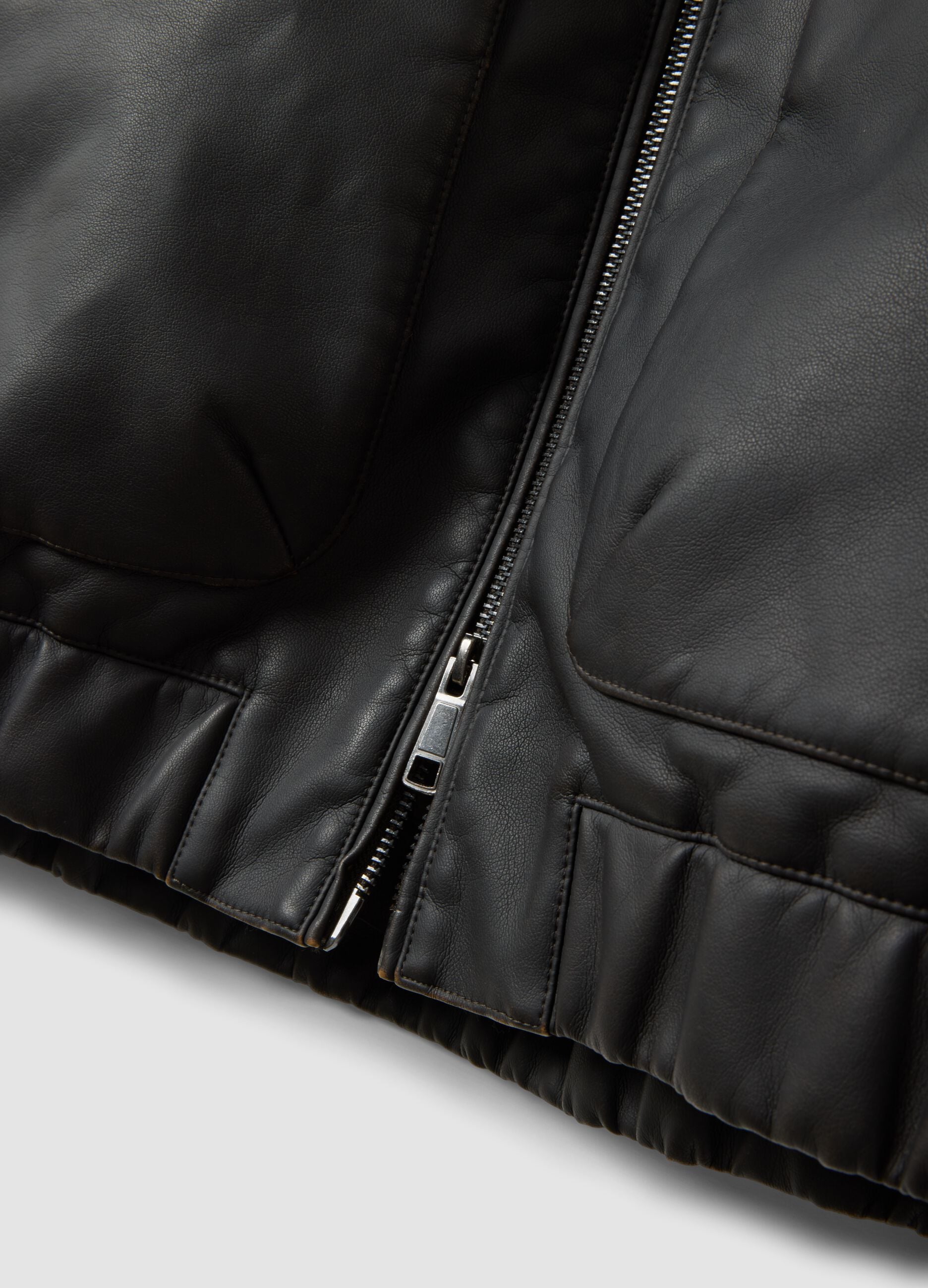Black cropped jacket with zip and flap pockets, oversized fit