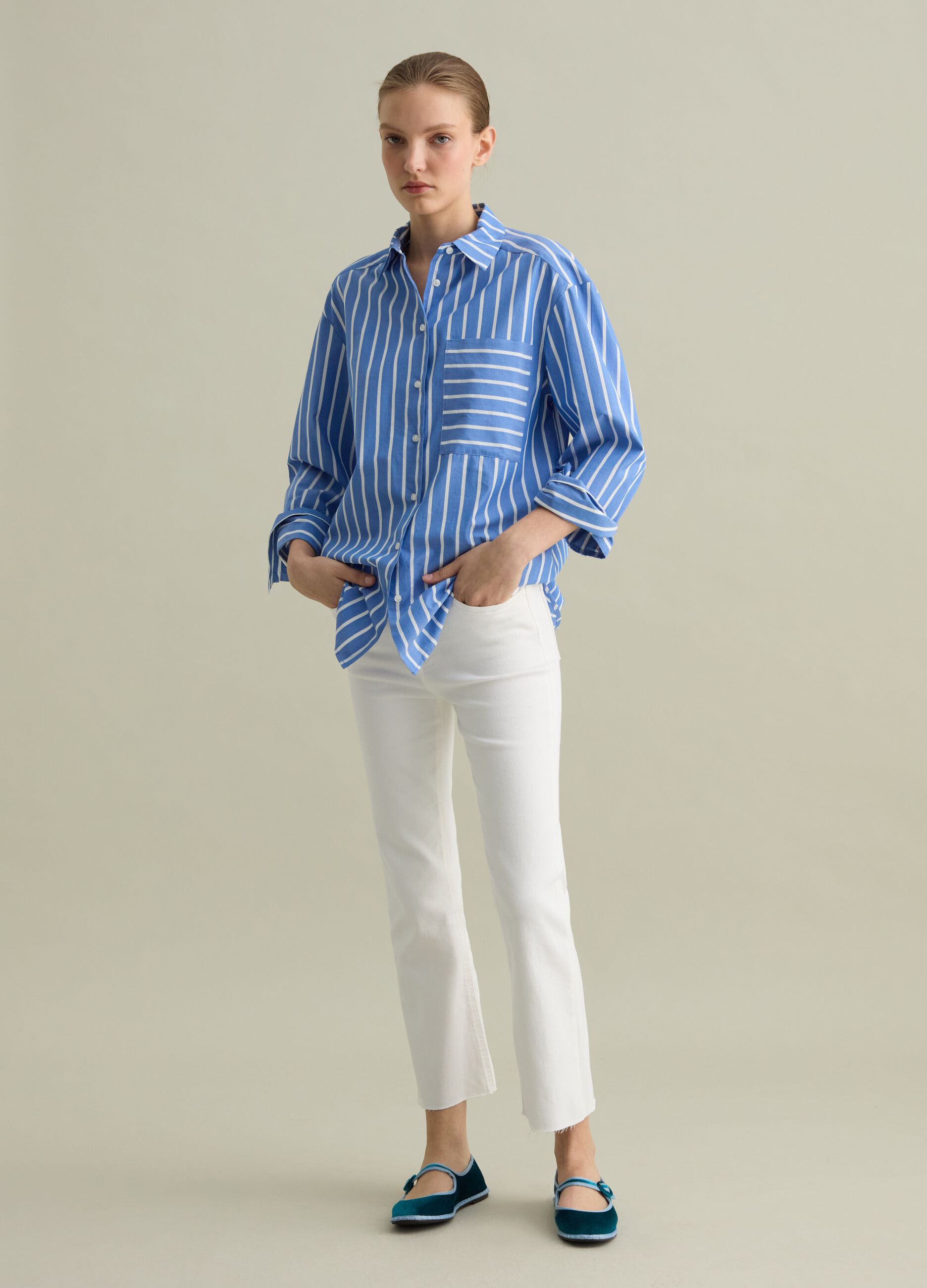Cropped white flare-fit jeans with raw edging