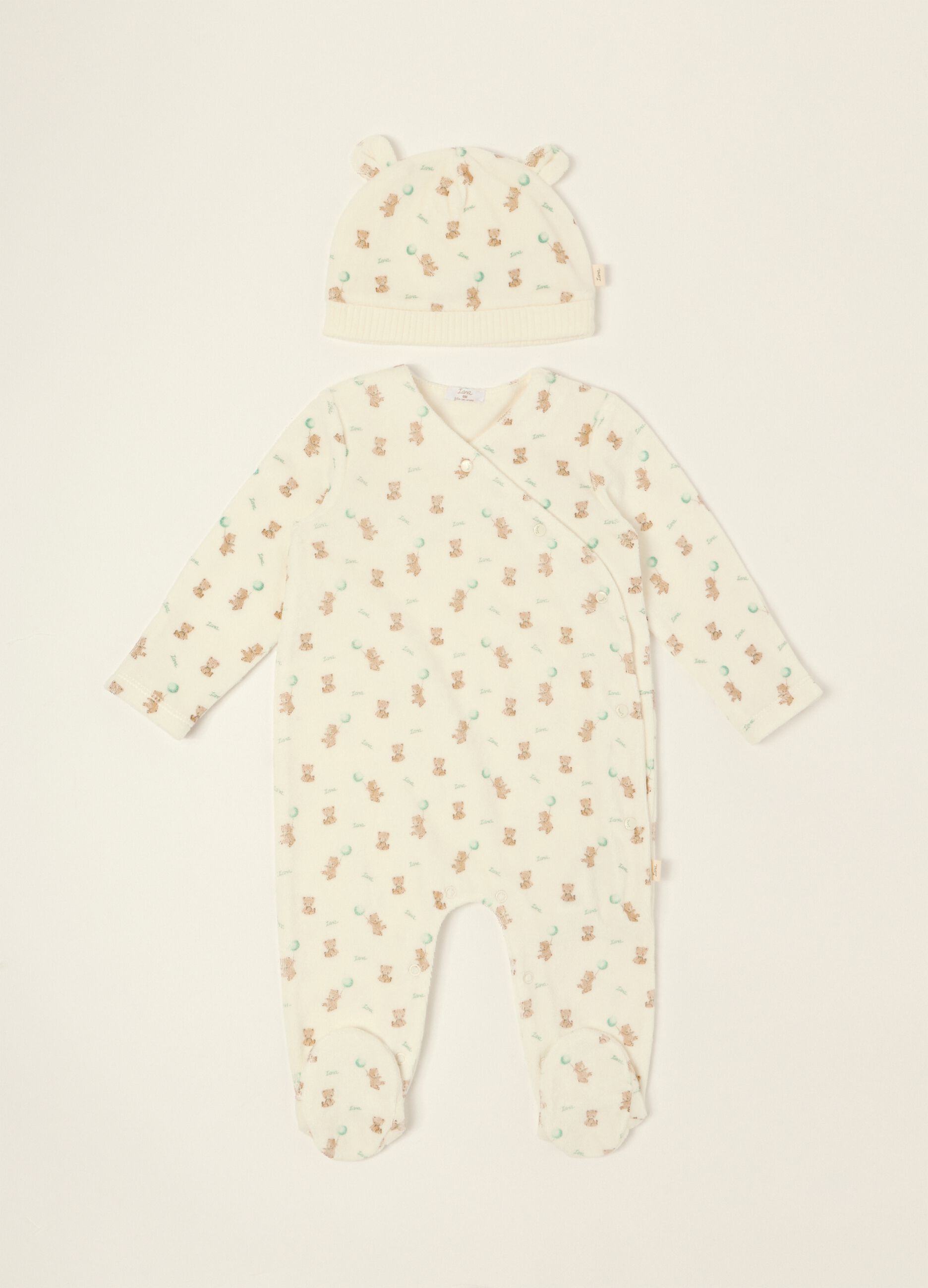White baby sleepsuit with teddy bear print