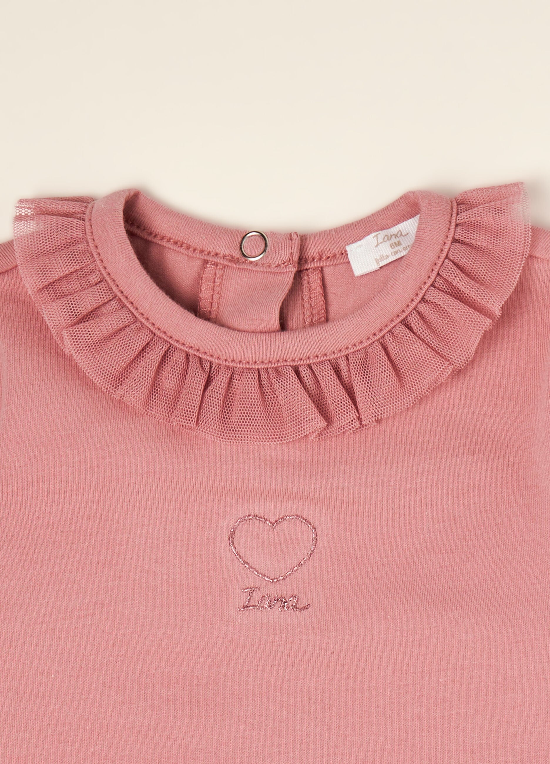 Pink organic stretch cotton bodysuit with ruffled crew neck