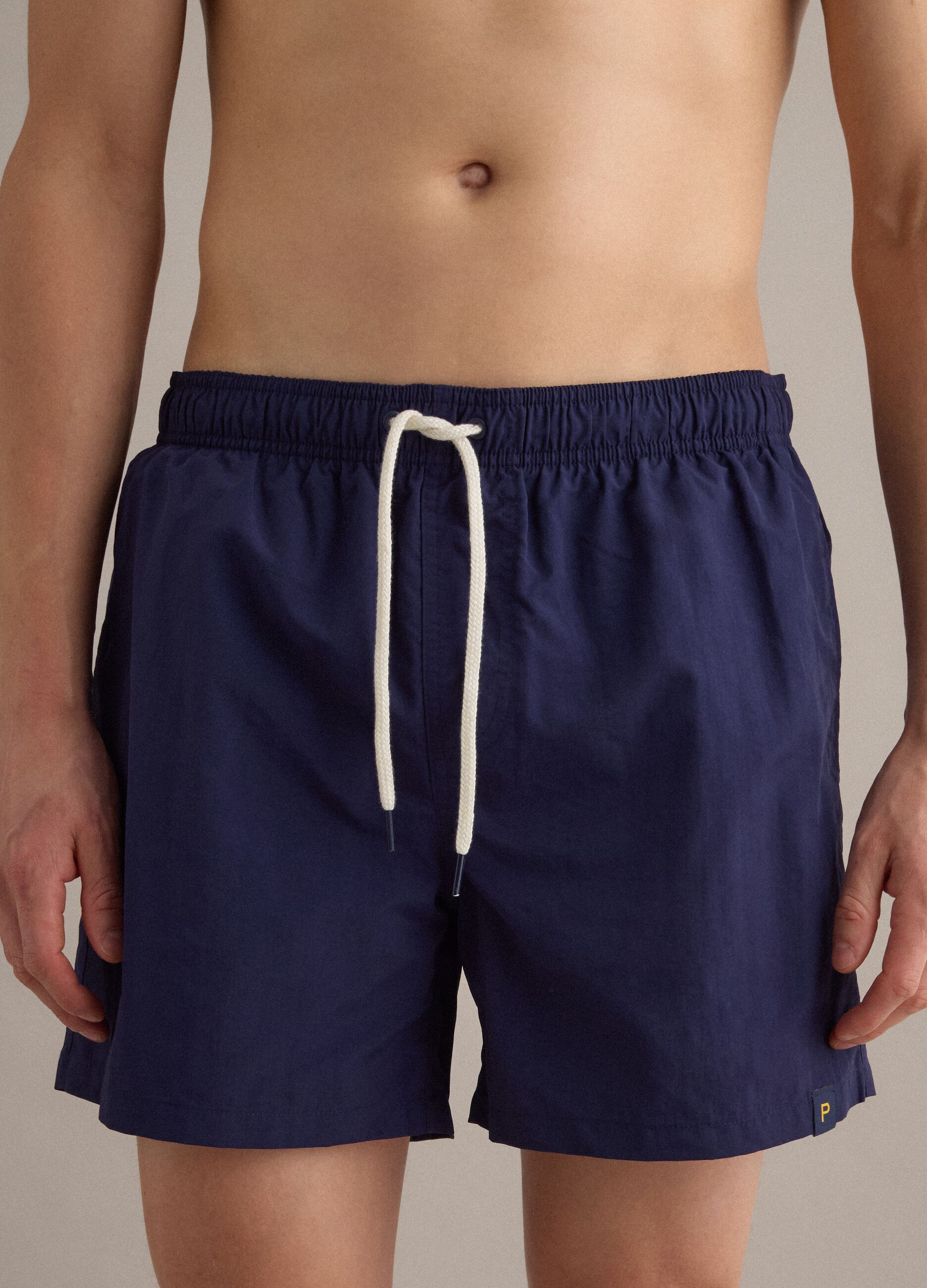 Blue swim shorts with elasticated waistband and drawstring