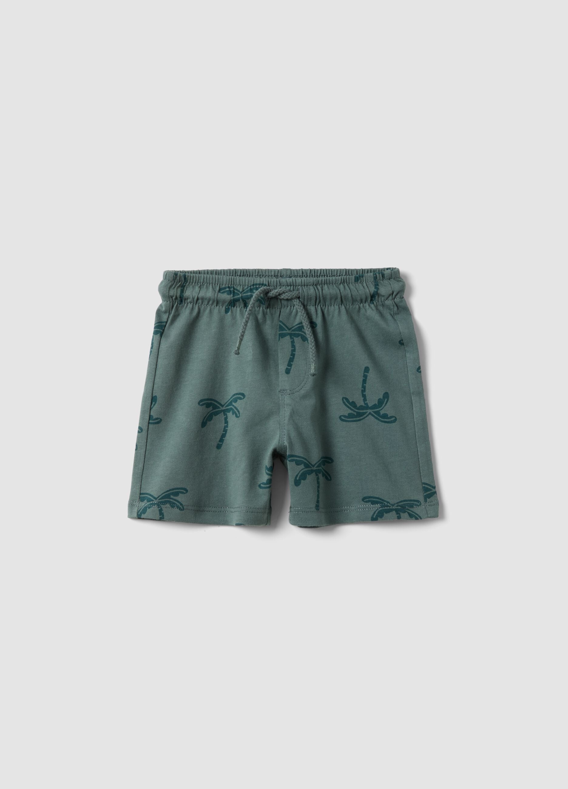 Green organic cotton shorts with palm print