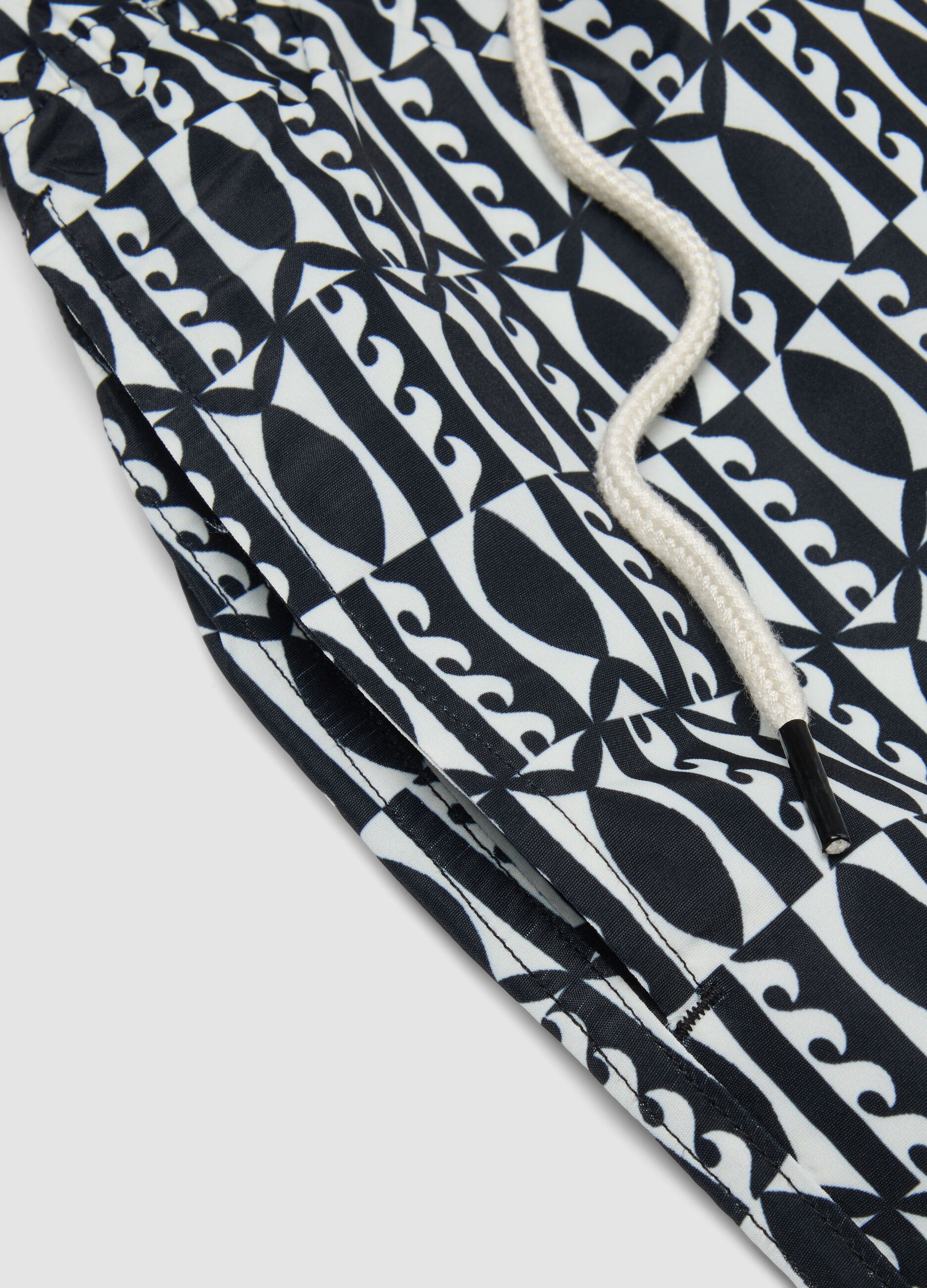 Blue swim shorts with graphic print