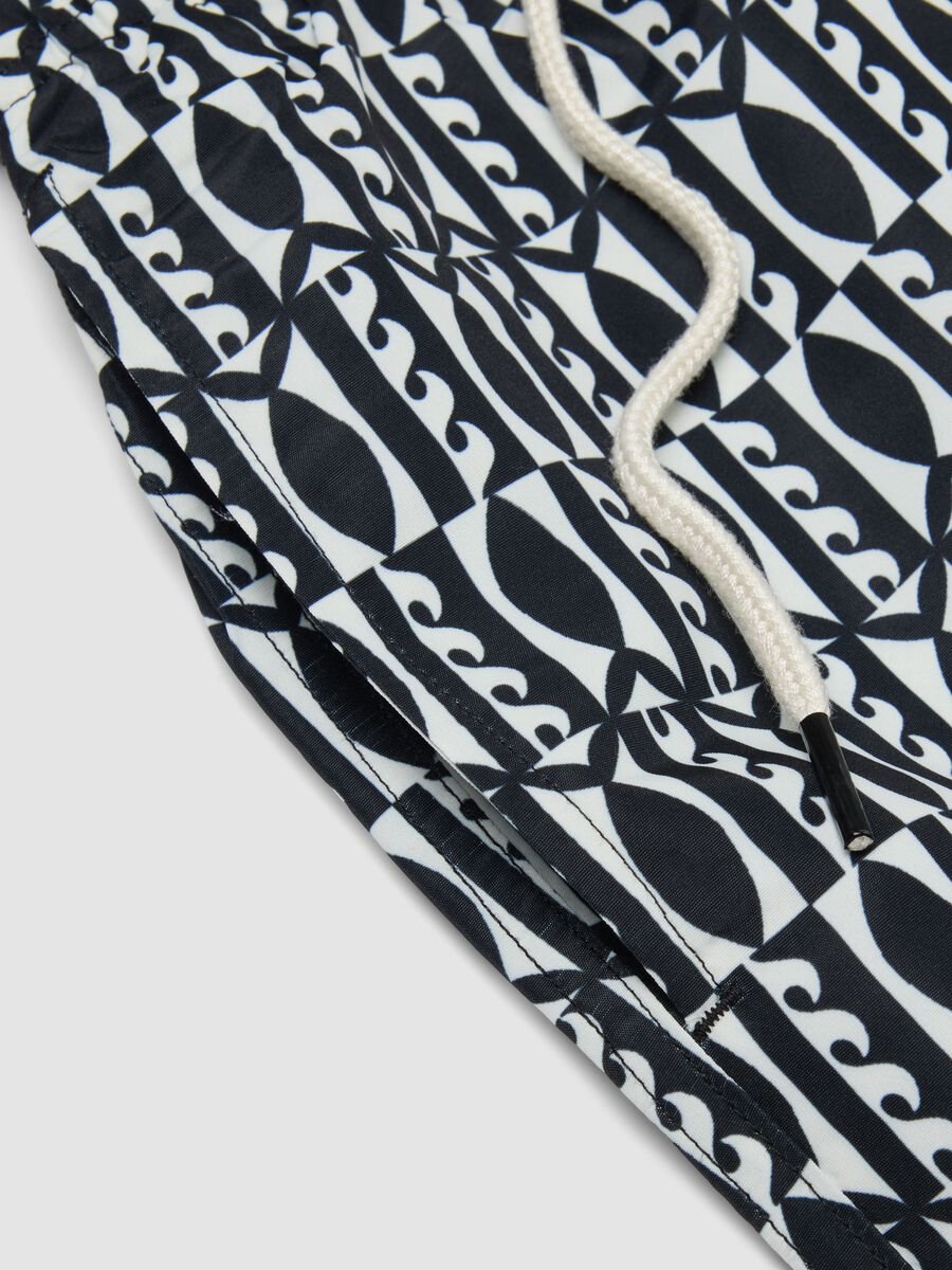 Blue swim shorts with graphic print_1