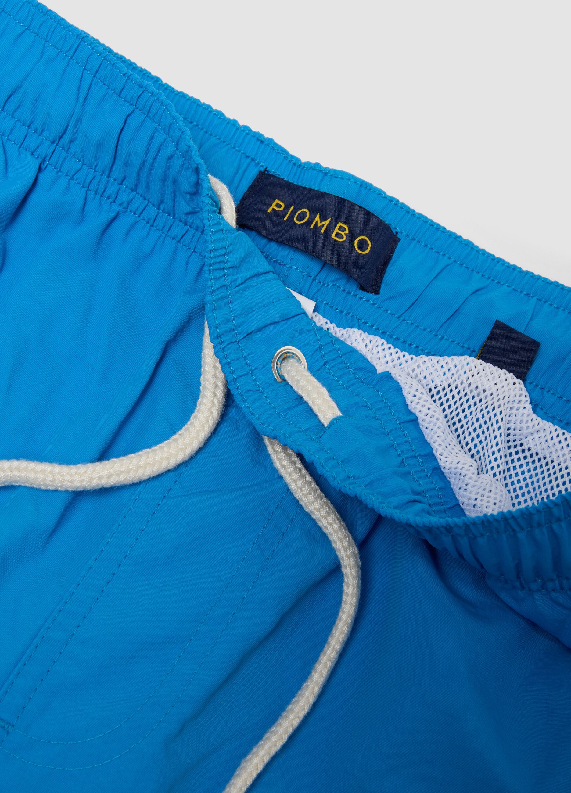 Blue swim shorts with elasticated waistband and contrast drawstring