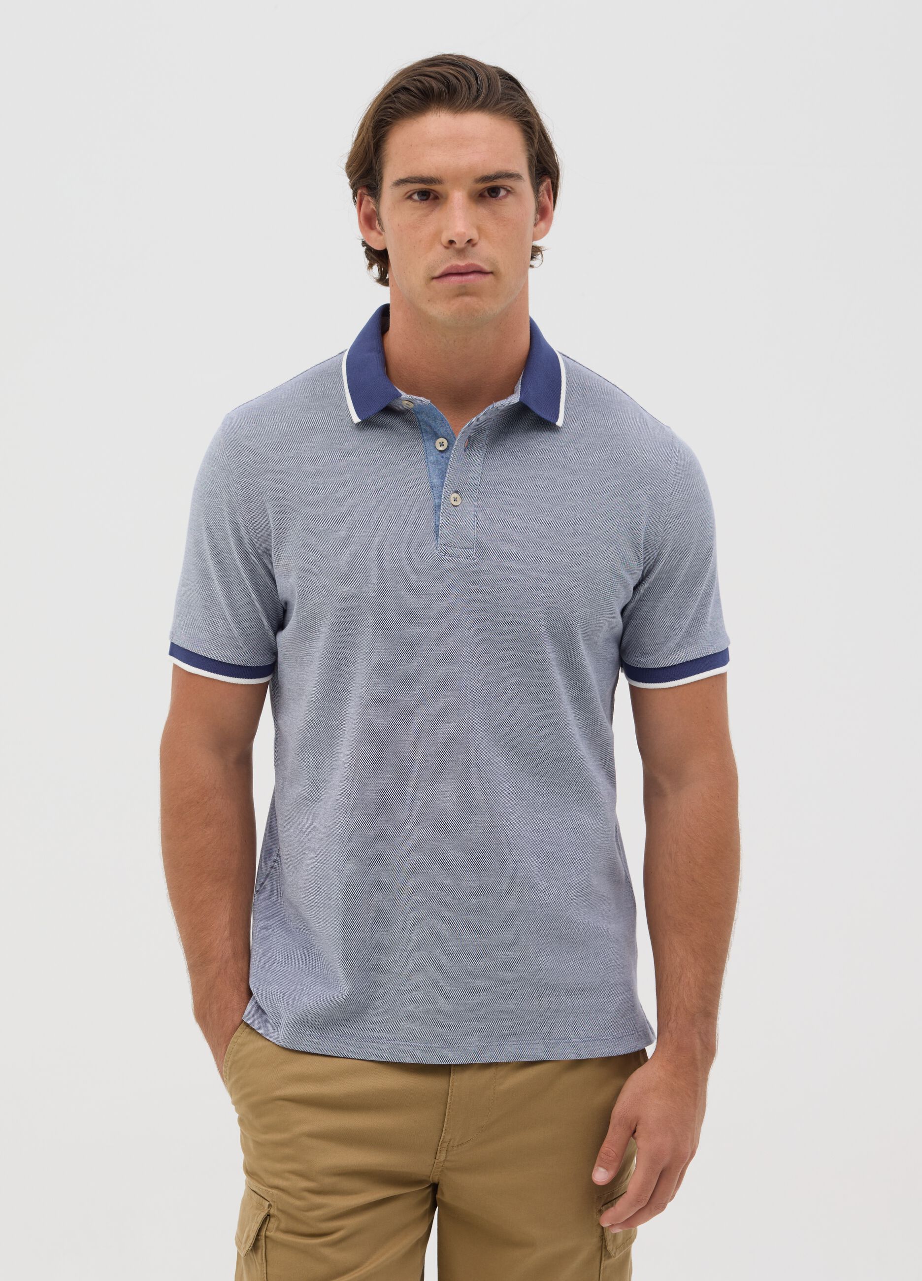 Blue polo shirt with short sleeves in cotton piquet