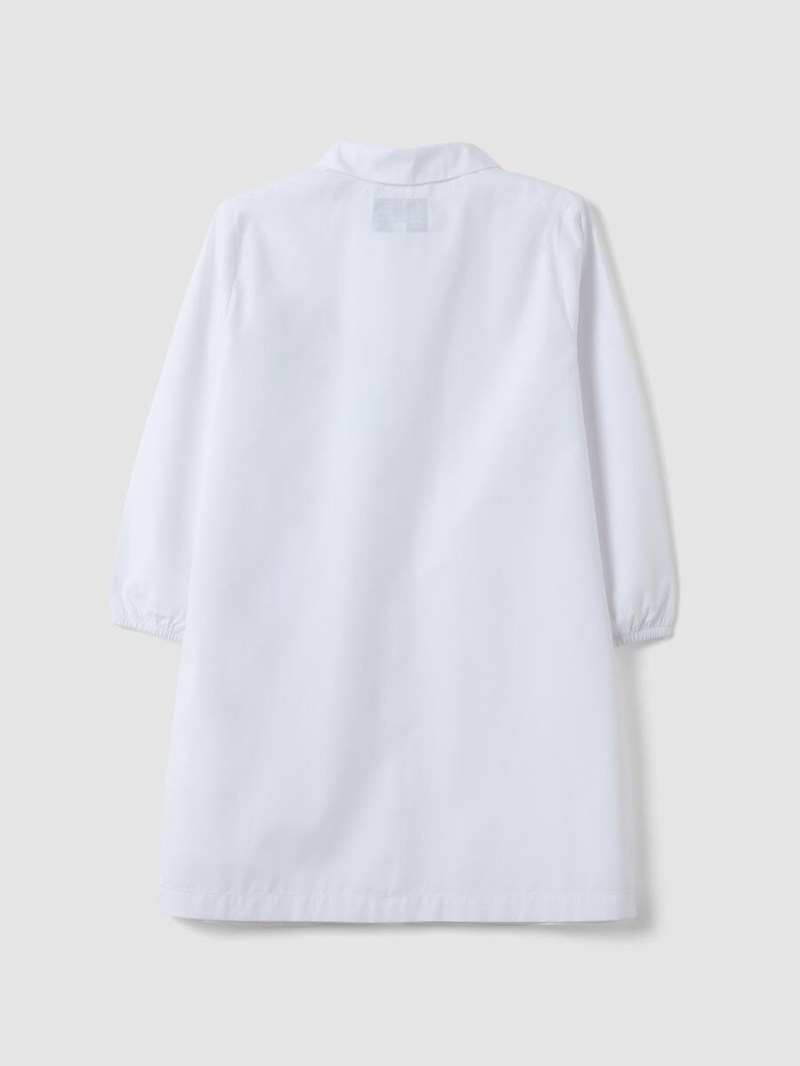 White nursery apron with zip and dinosaur embroidery for boys_1
