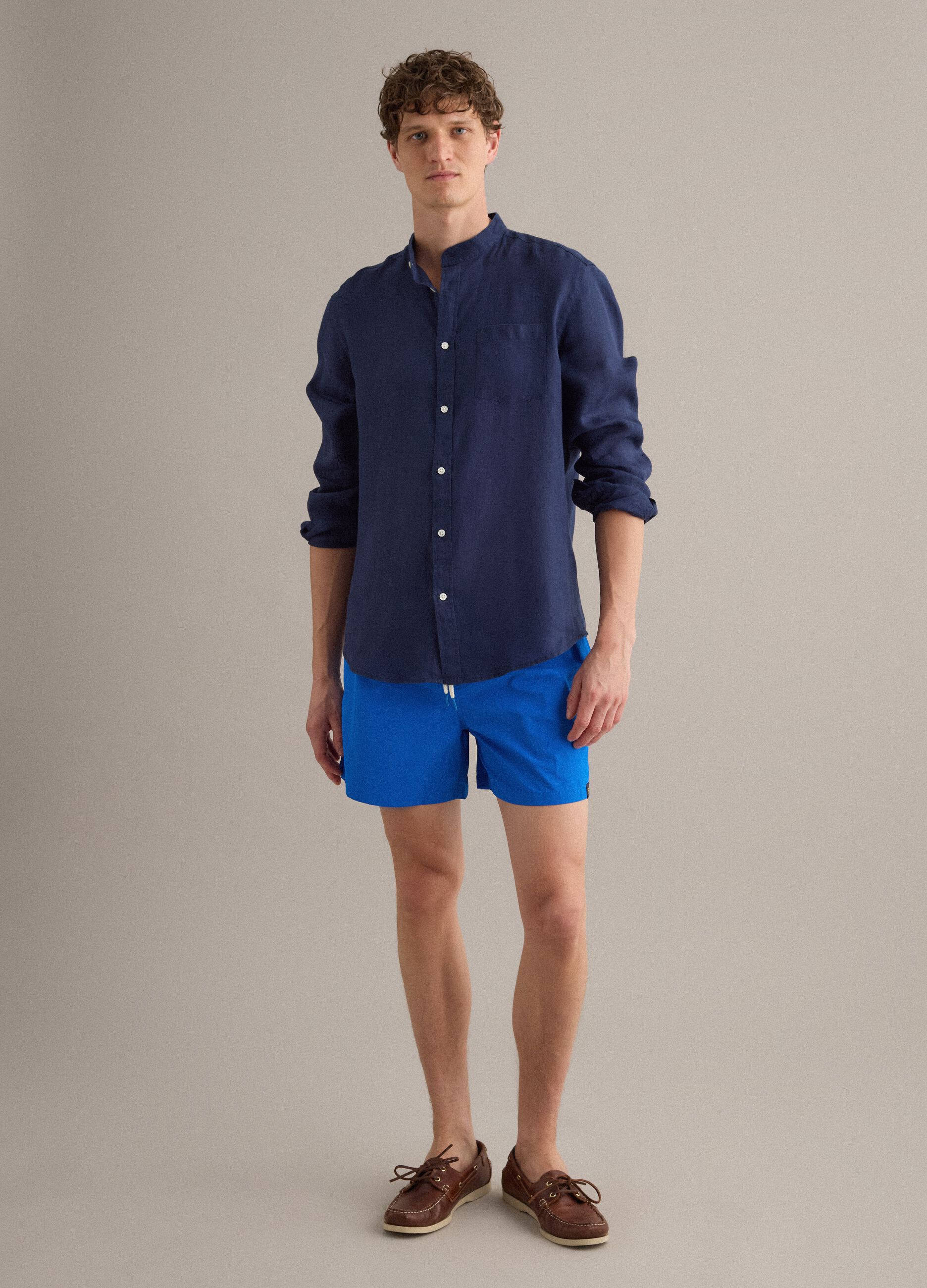 Blue swim shorts with elasticated waist and drawstring