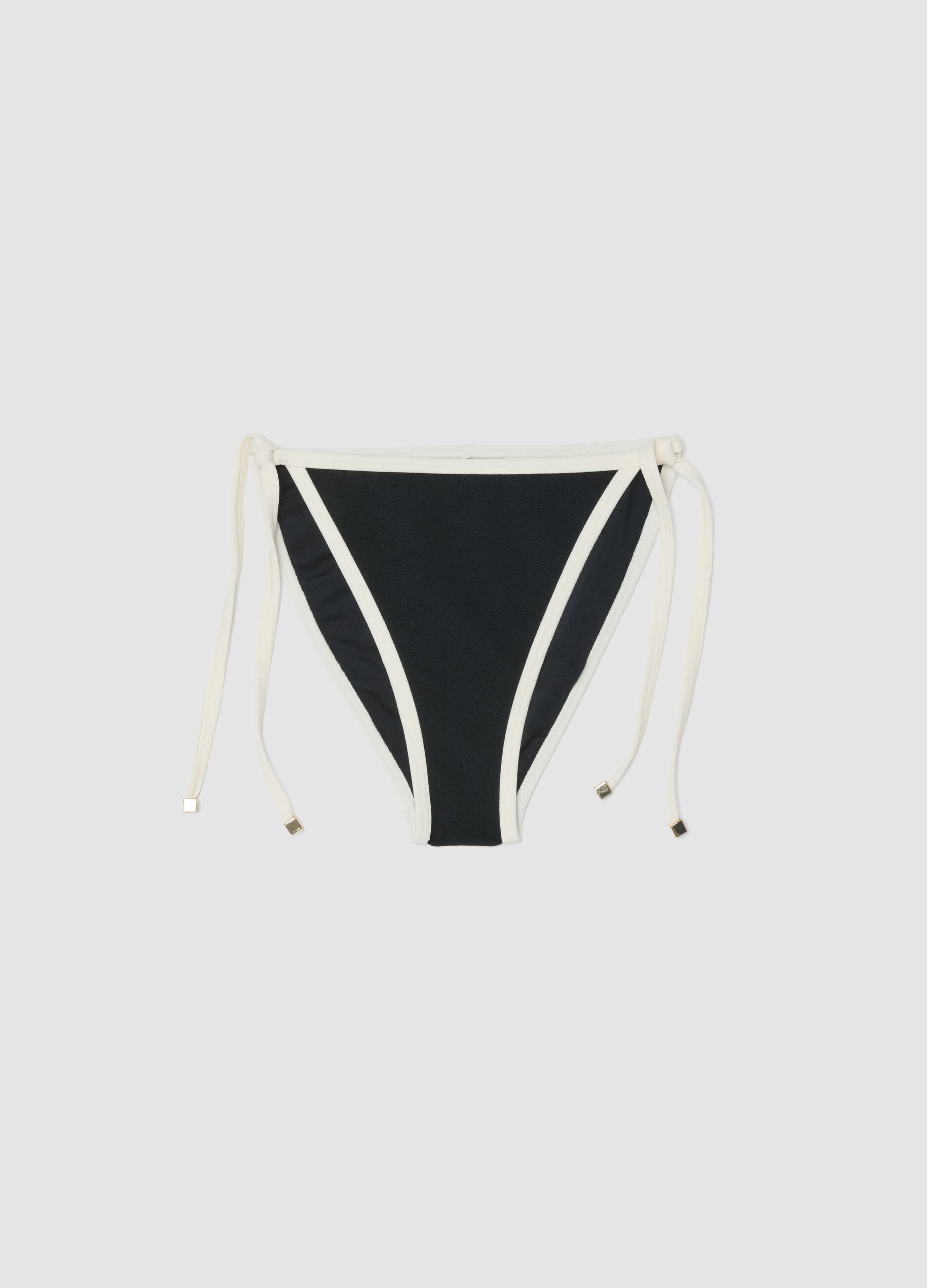 Black and white bikini bottoms in stretch fabric with side ties