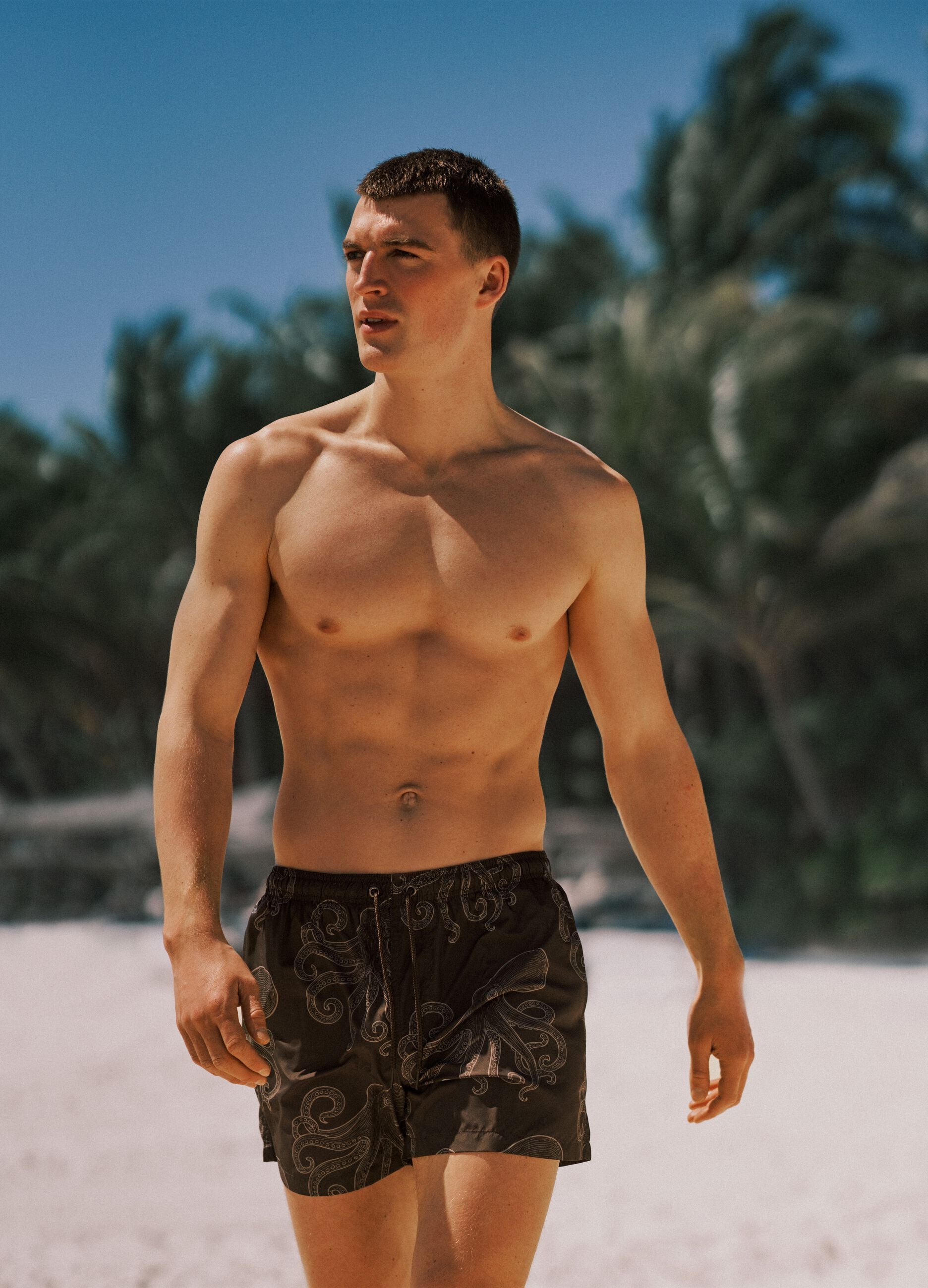Brown swim shorts with all-over print