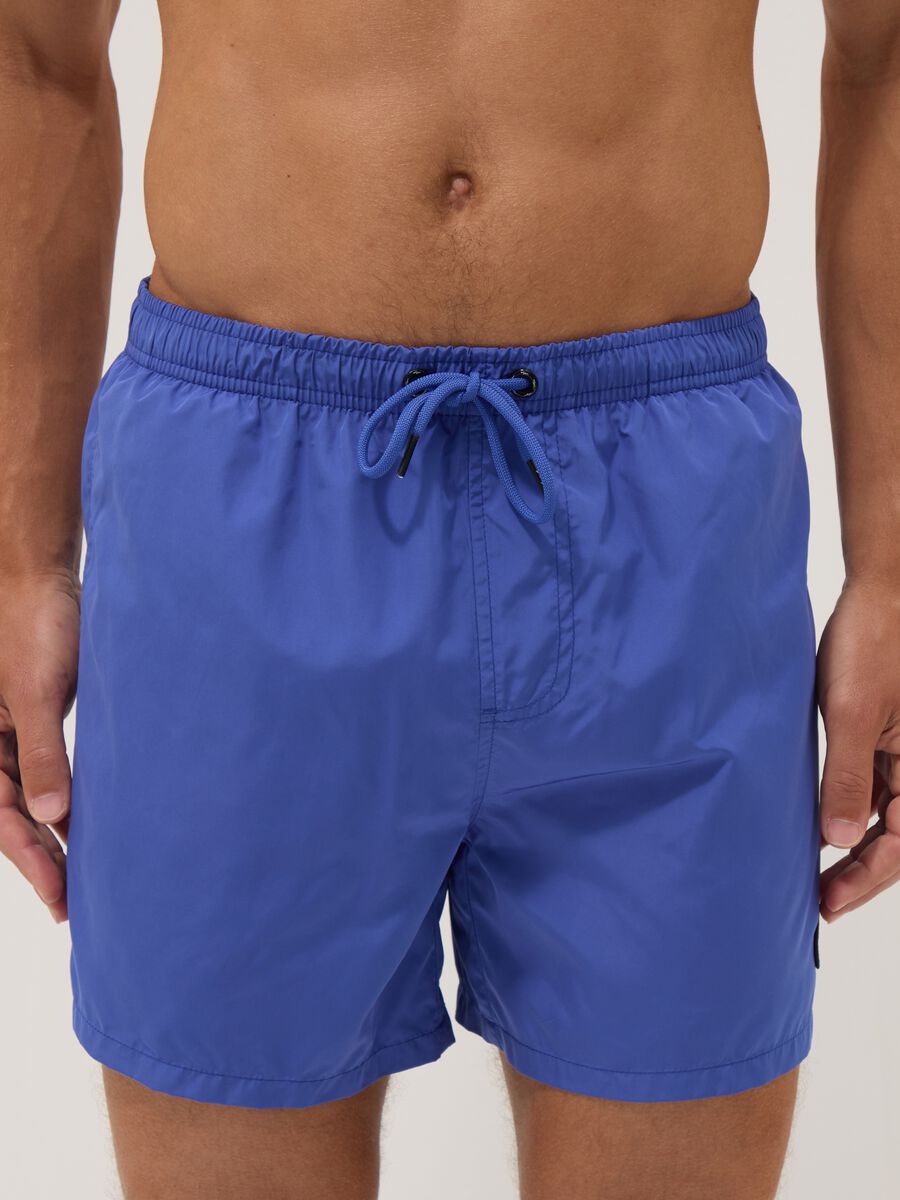 Blue swim shorts with elasticated waistband and drawstring_2
