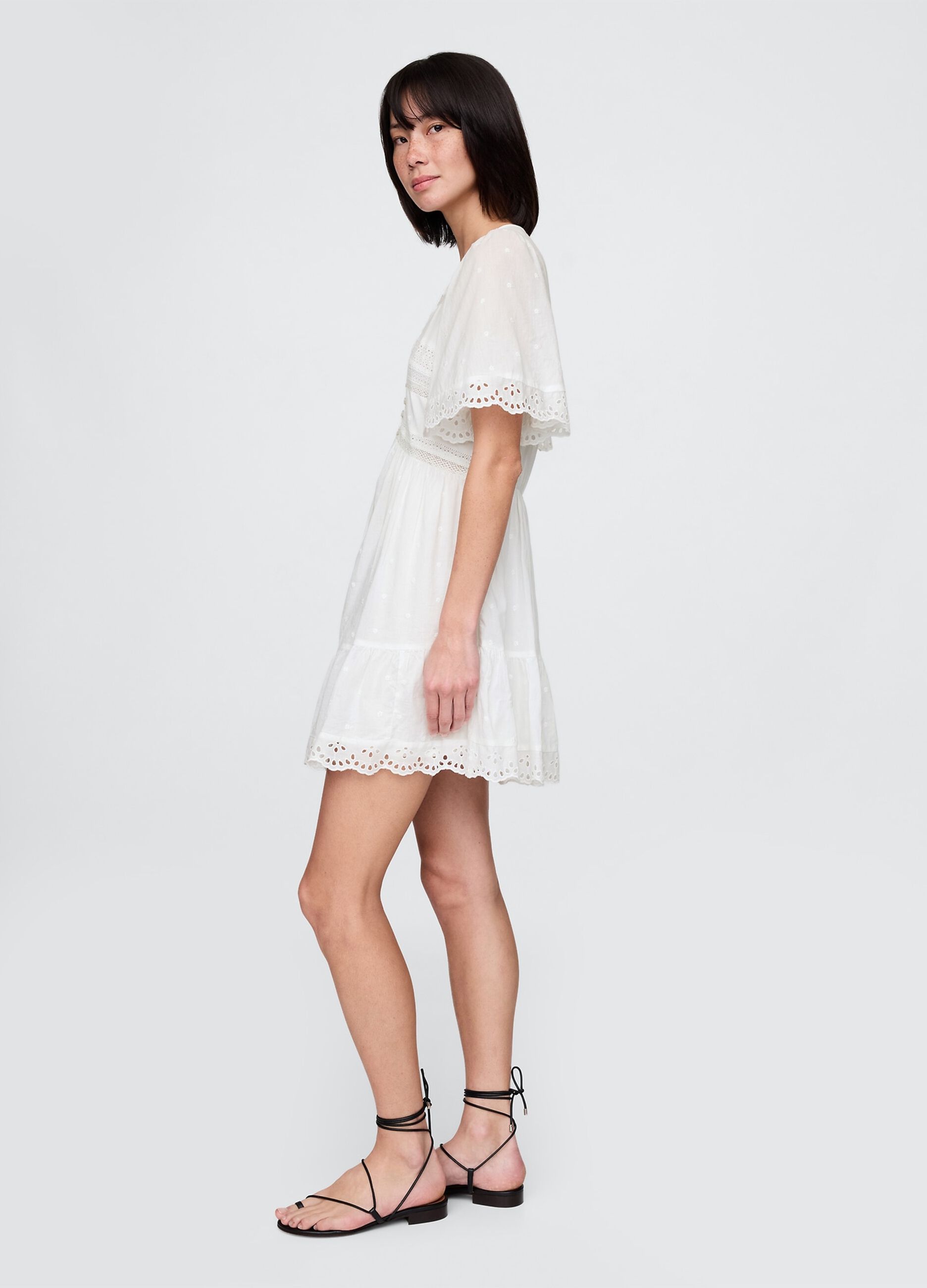 Short white dress in embroidered fabric