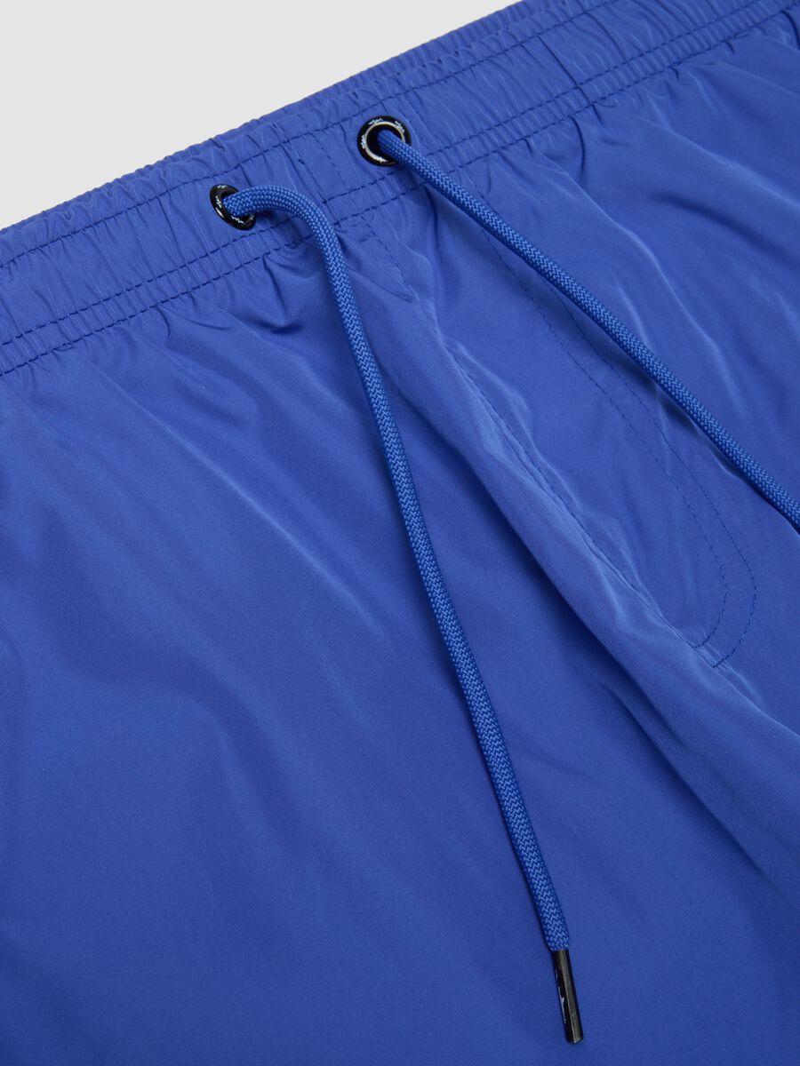 Blue swim shorts with elasticated waistband and drawstring_1