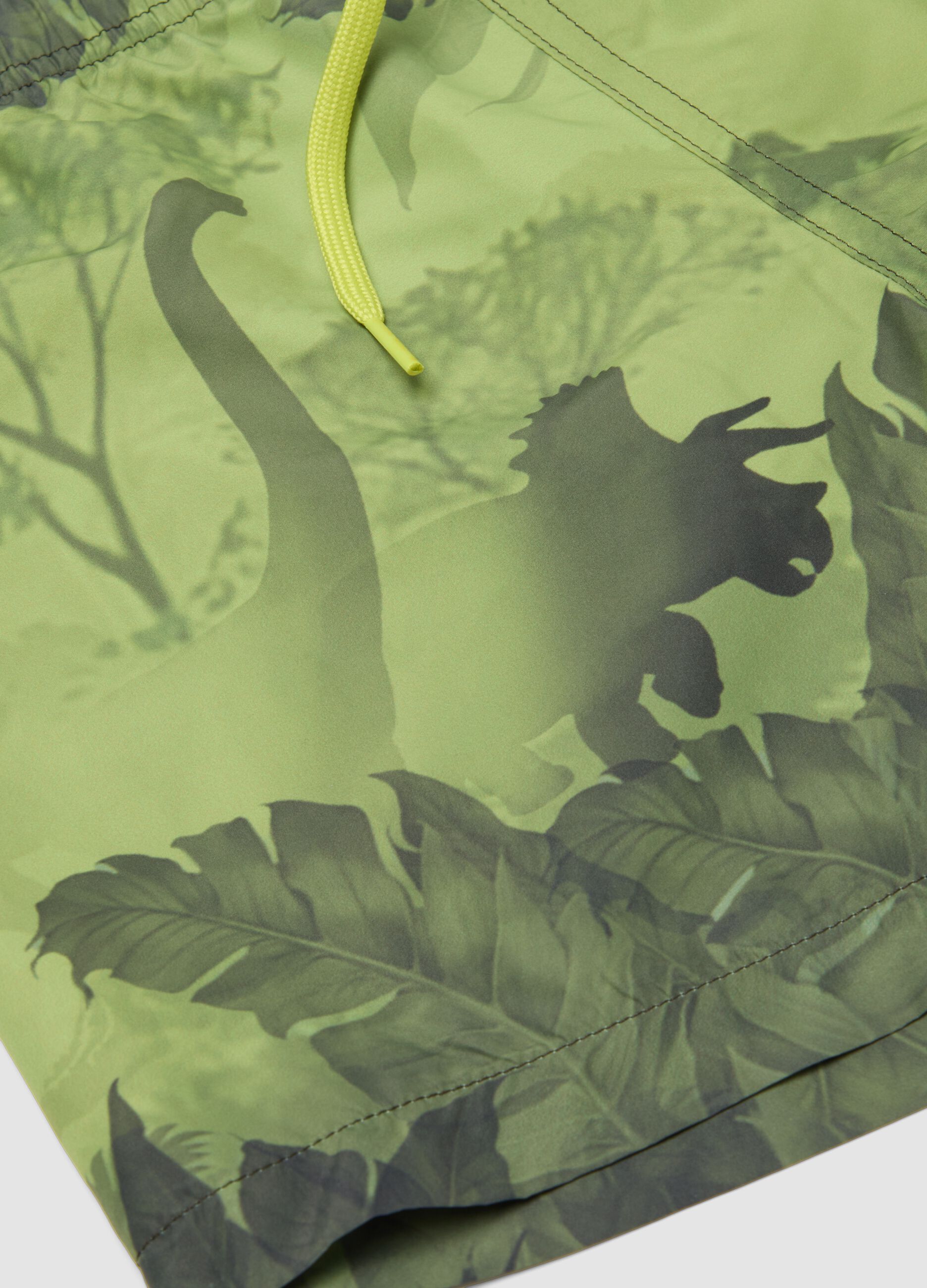 Green boys&rsquo; swim shorts with dinosaur print