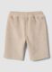 Pantaloni beige in tessuto elasticizzato a coste per neonata_1