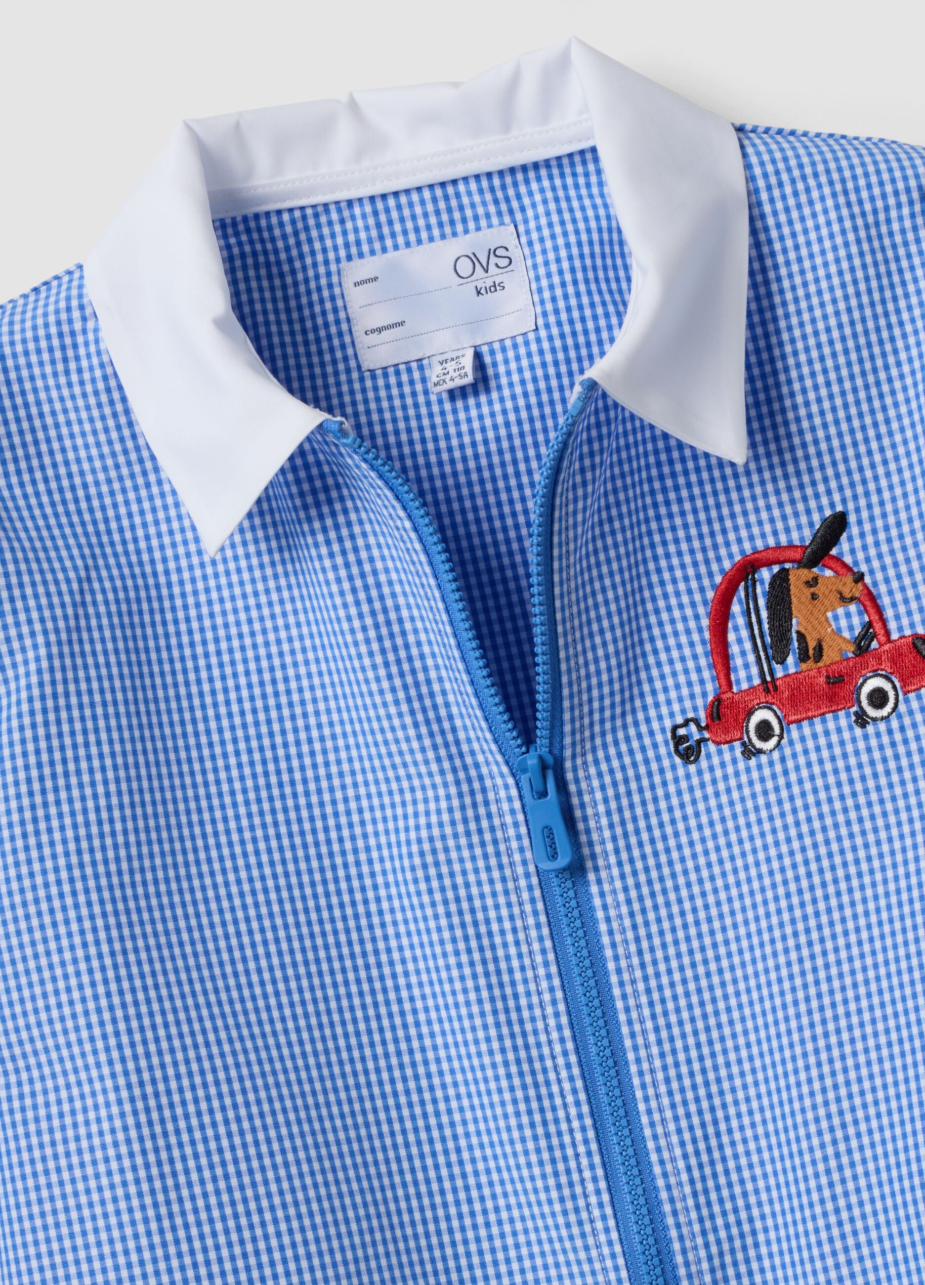 Light blue gingham nursery apron with zip and machine embroidery