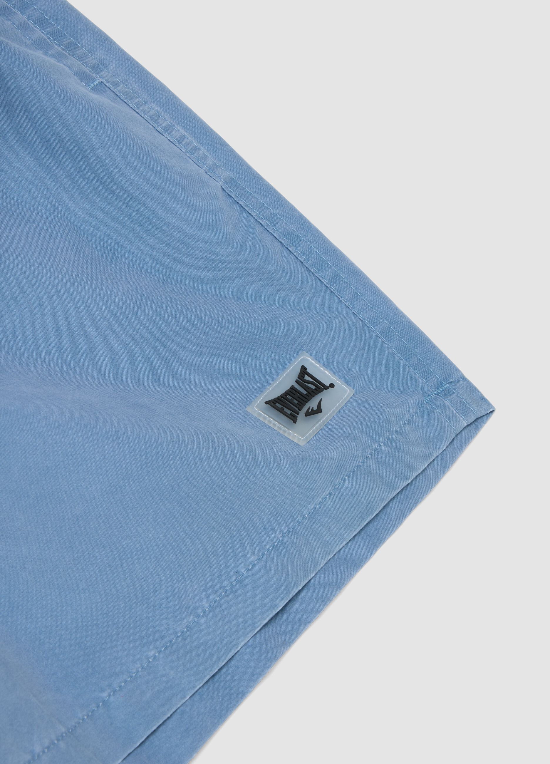 Blue swim shorts with drawstring waist