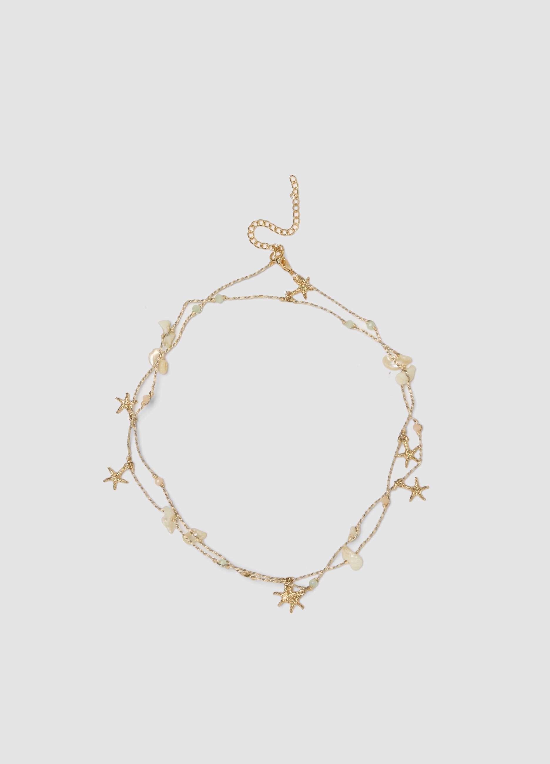 Beige necklace with sea charms and stones