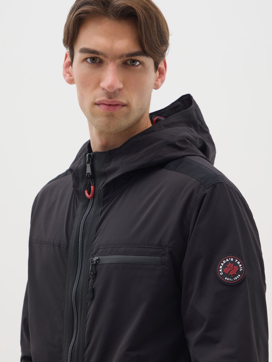 Black jacket in heavy fabric with hood and zip_3
