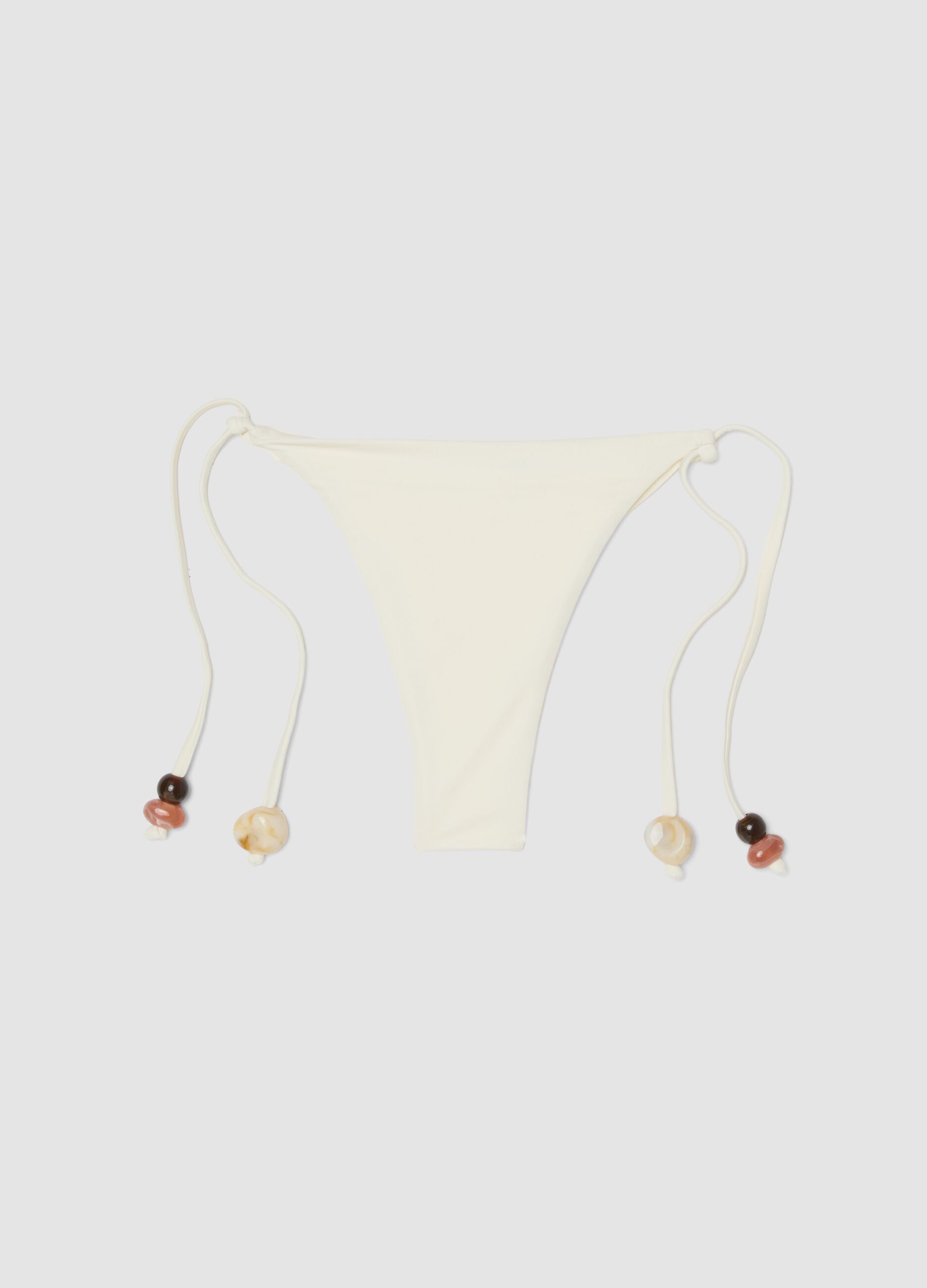 White stretch bikini bottoms with side ties and stones