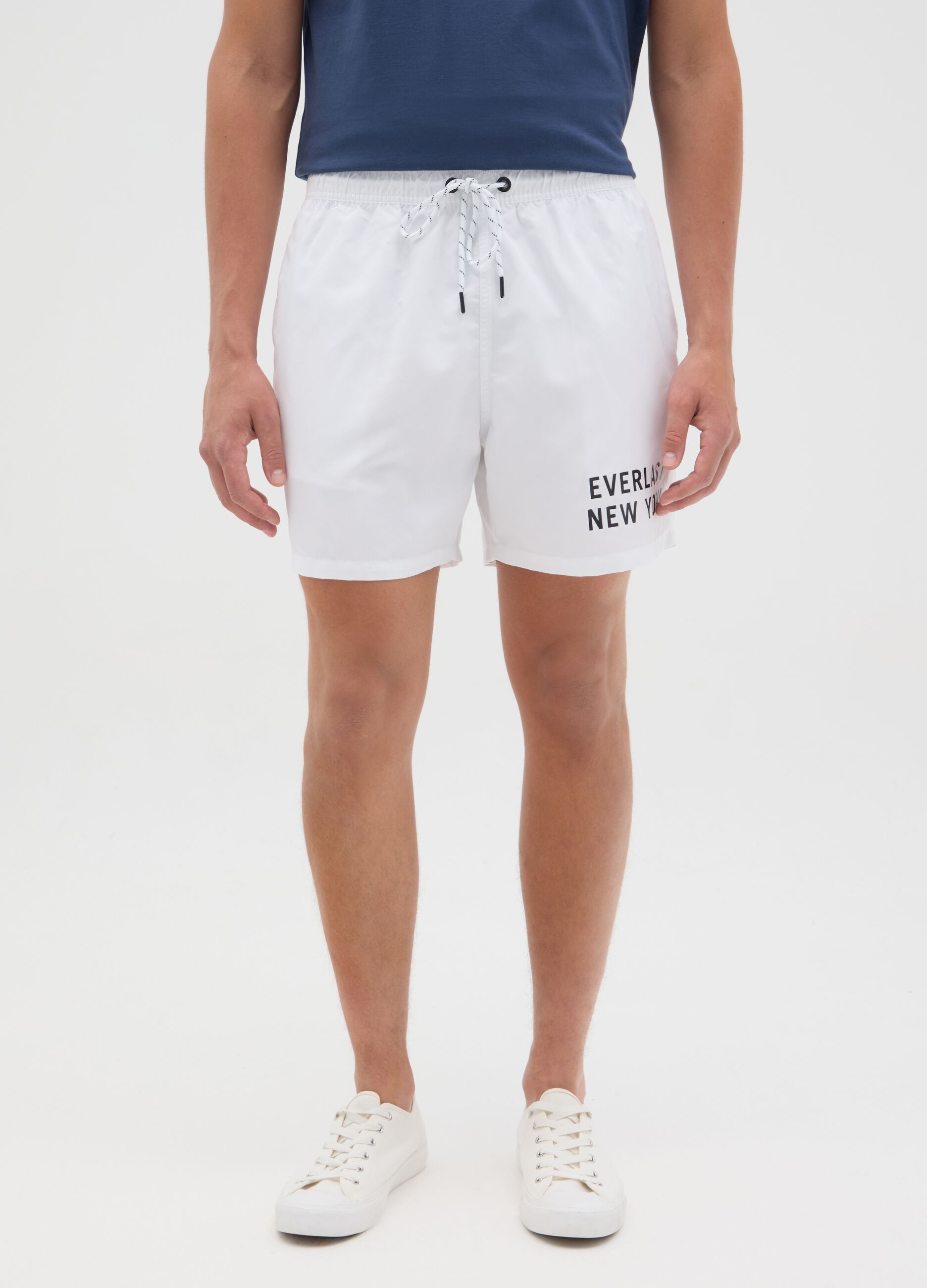 White swimming trunks with logo print