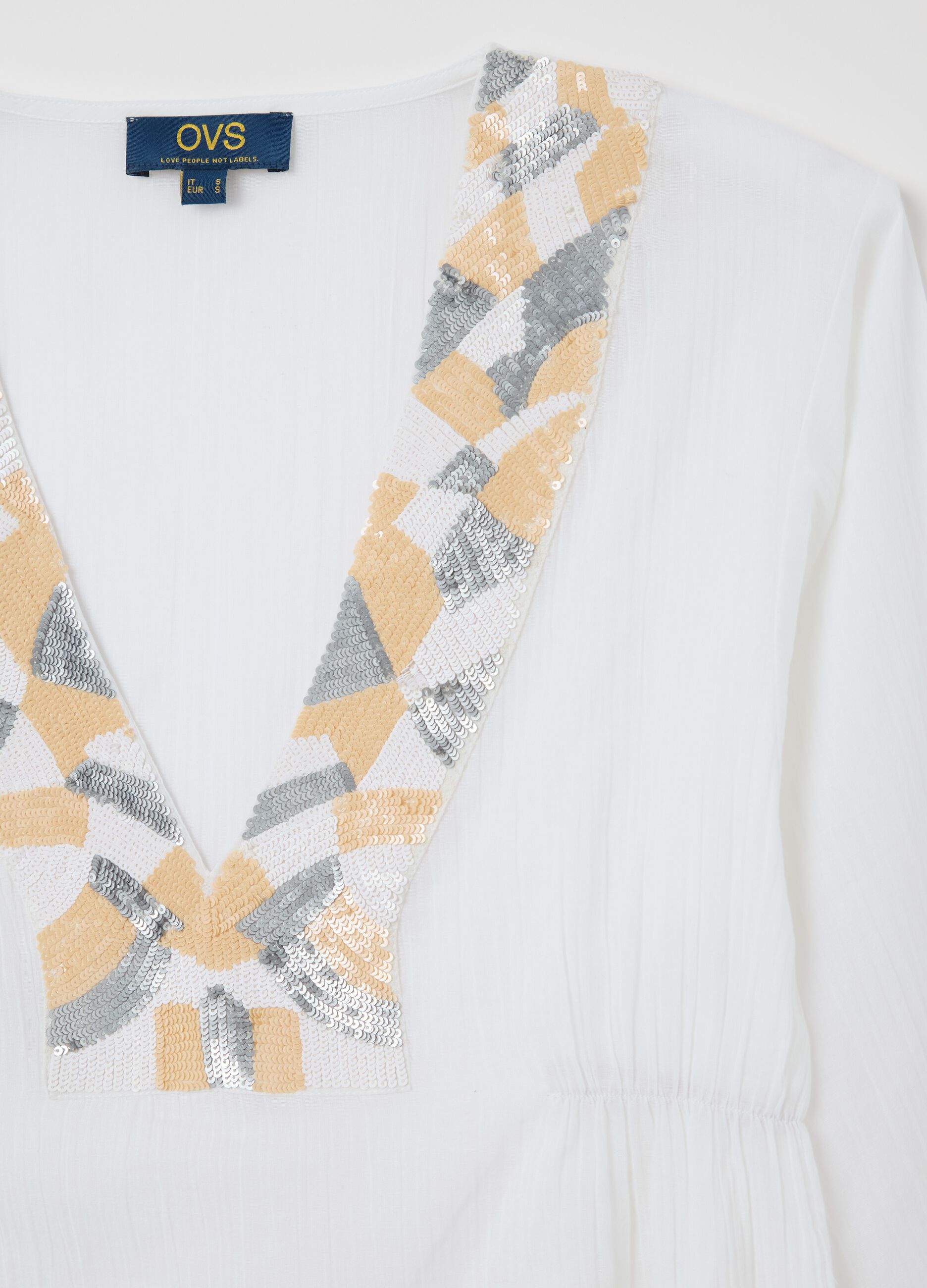 White beach cover-up with decorative edging