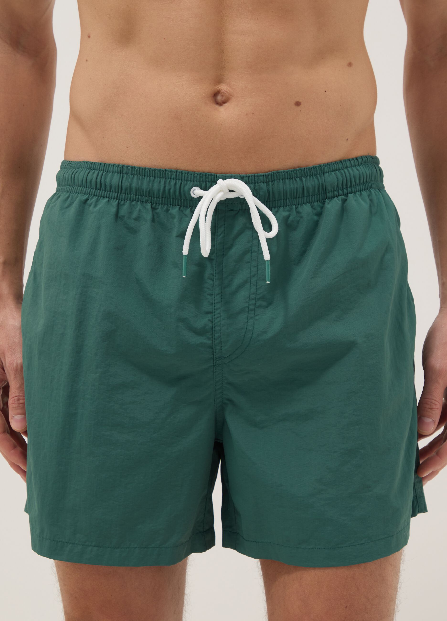 Green swim shorts with elasticated waist