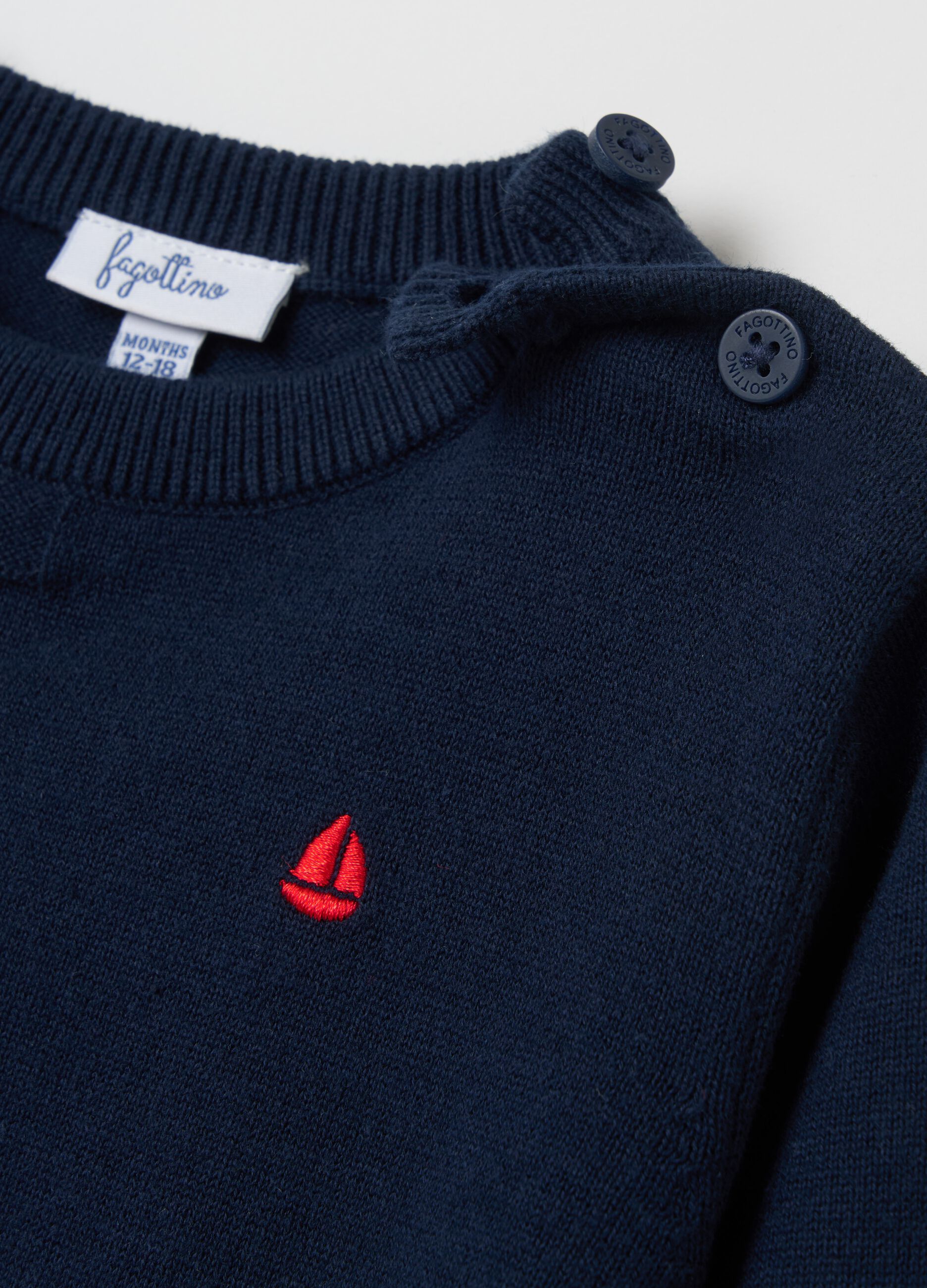 Pullover with embossed design and embroidered sailing boat