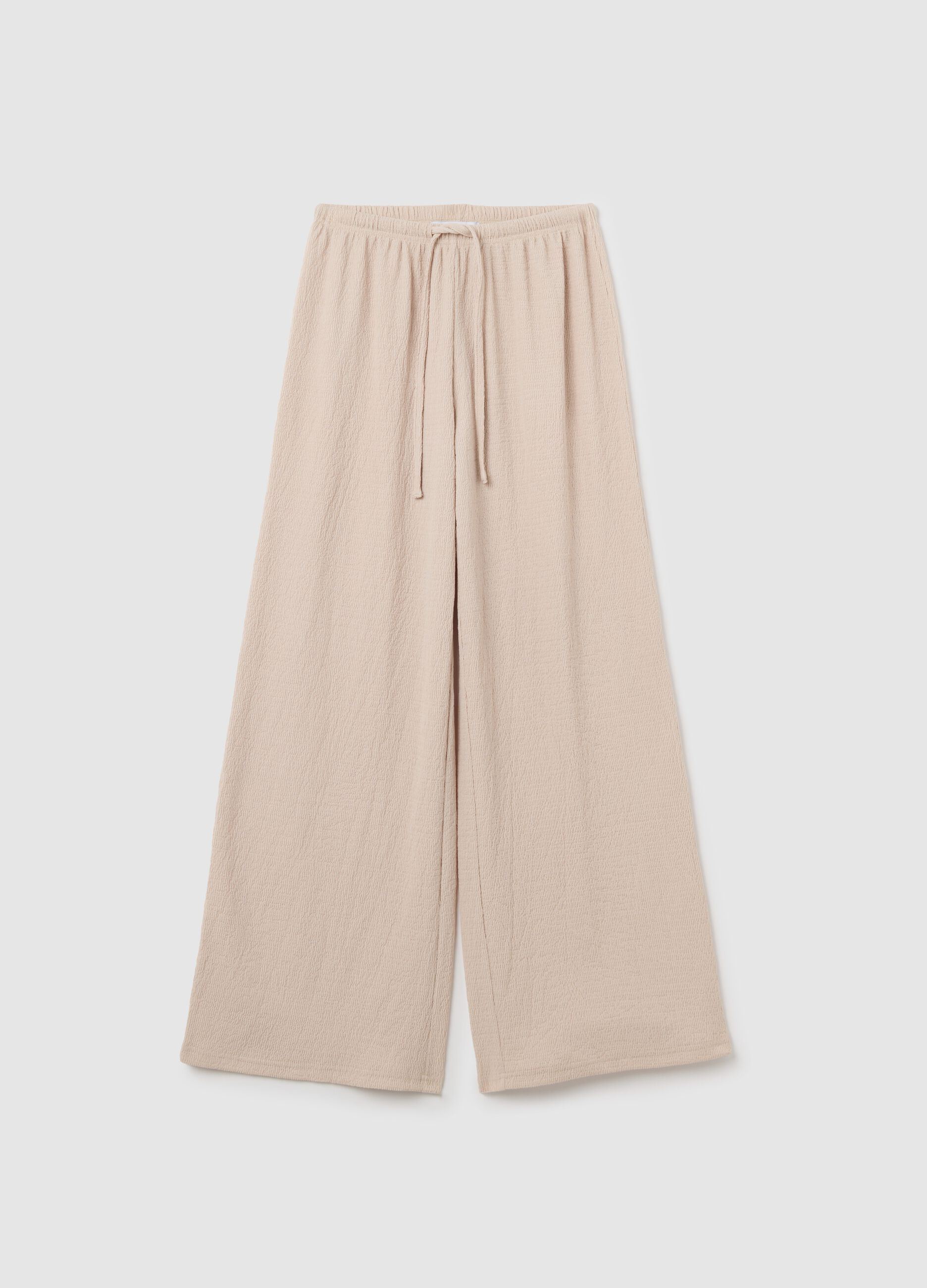 Women's beige regular-fit palazzo pants in stretch fabric.