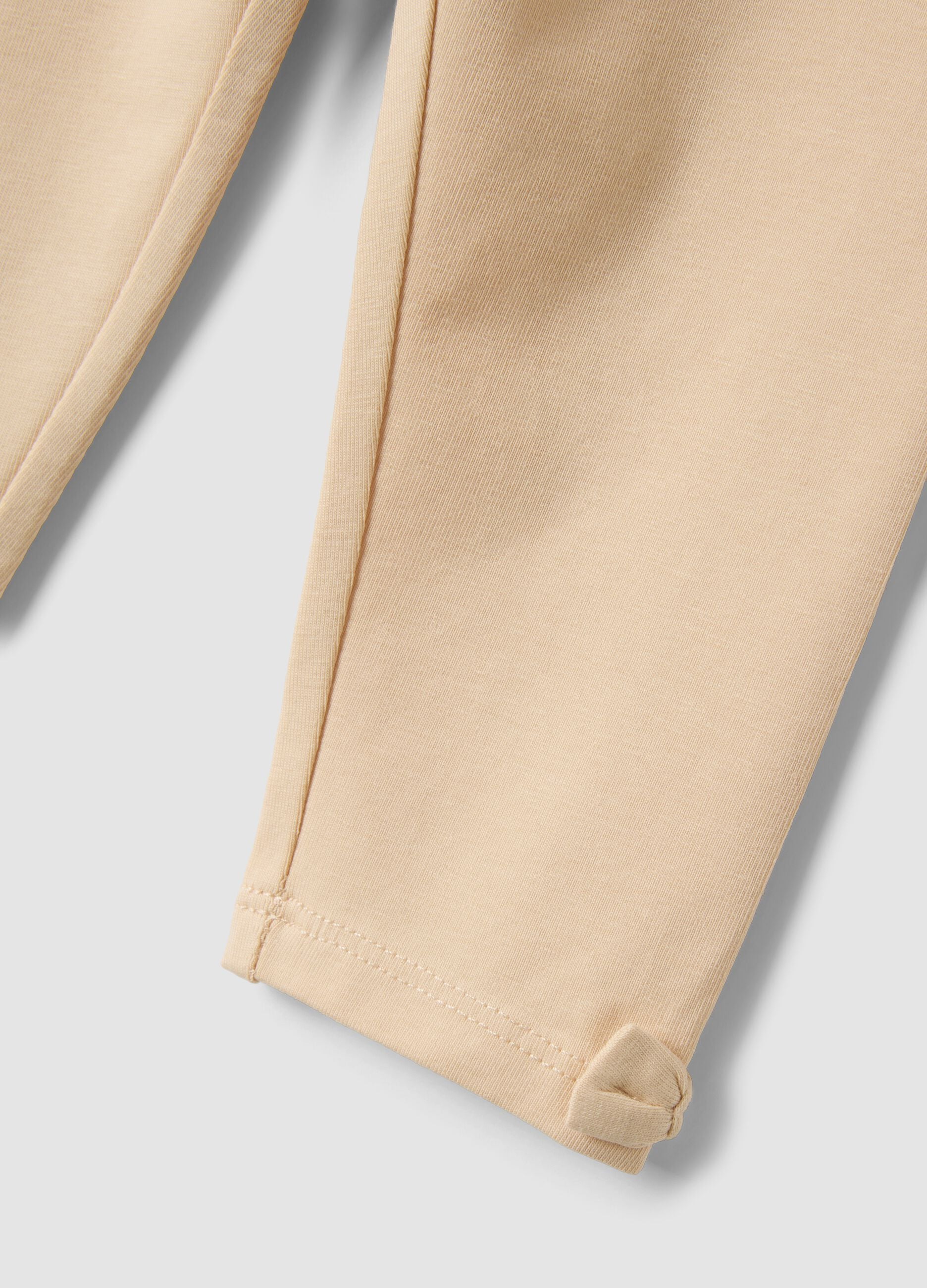 Beige stretch organic cotton leggings with bows for baby girl