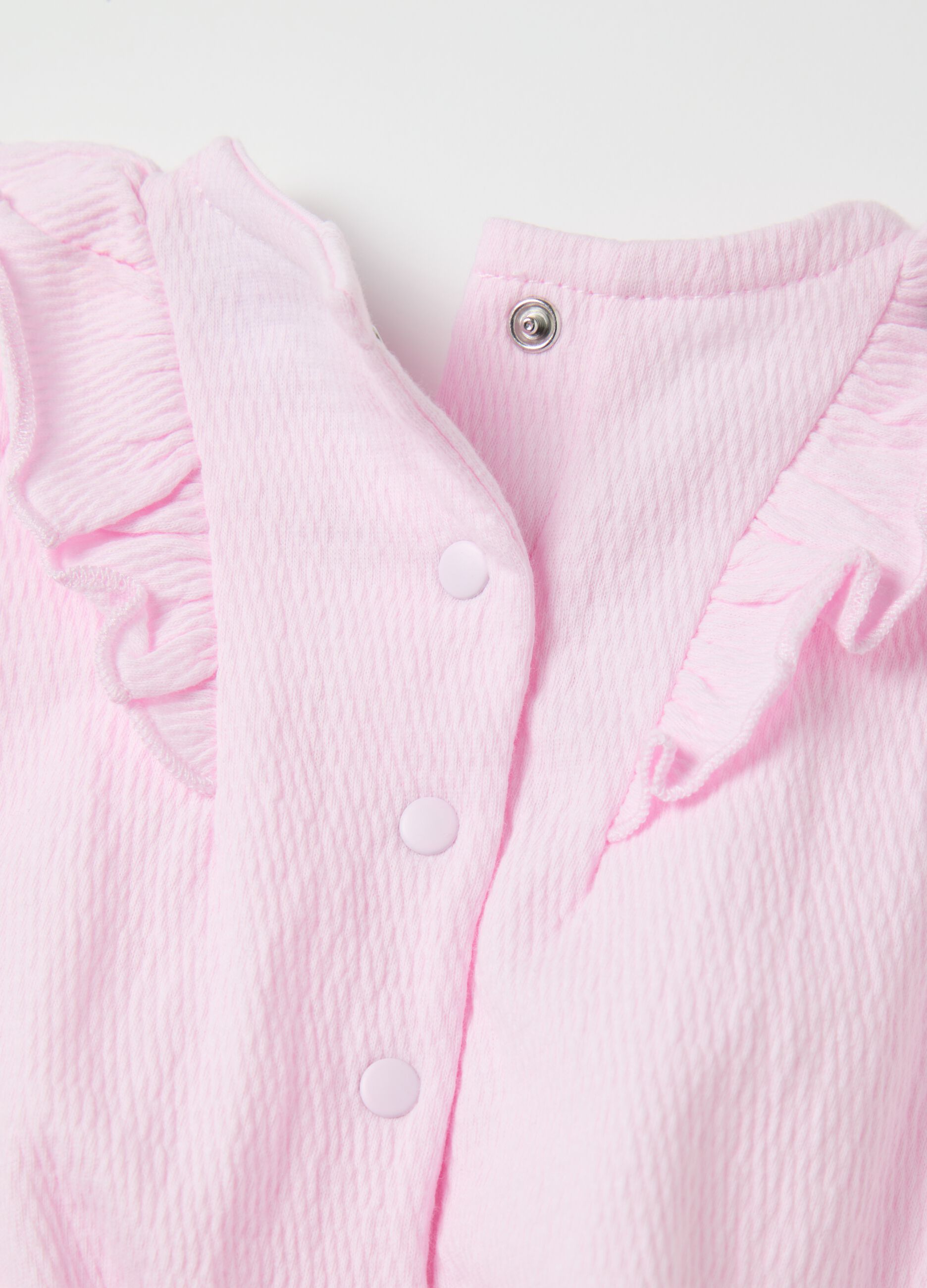 Pink sleeveless bodysuit with flounce