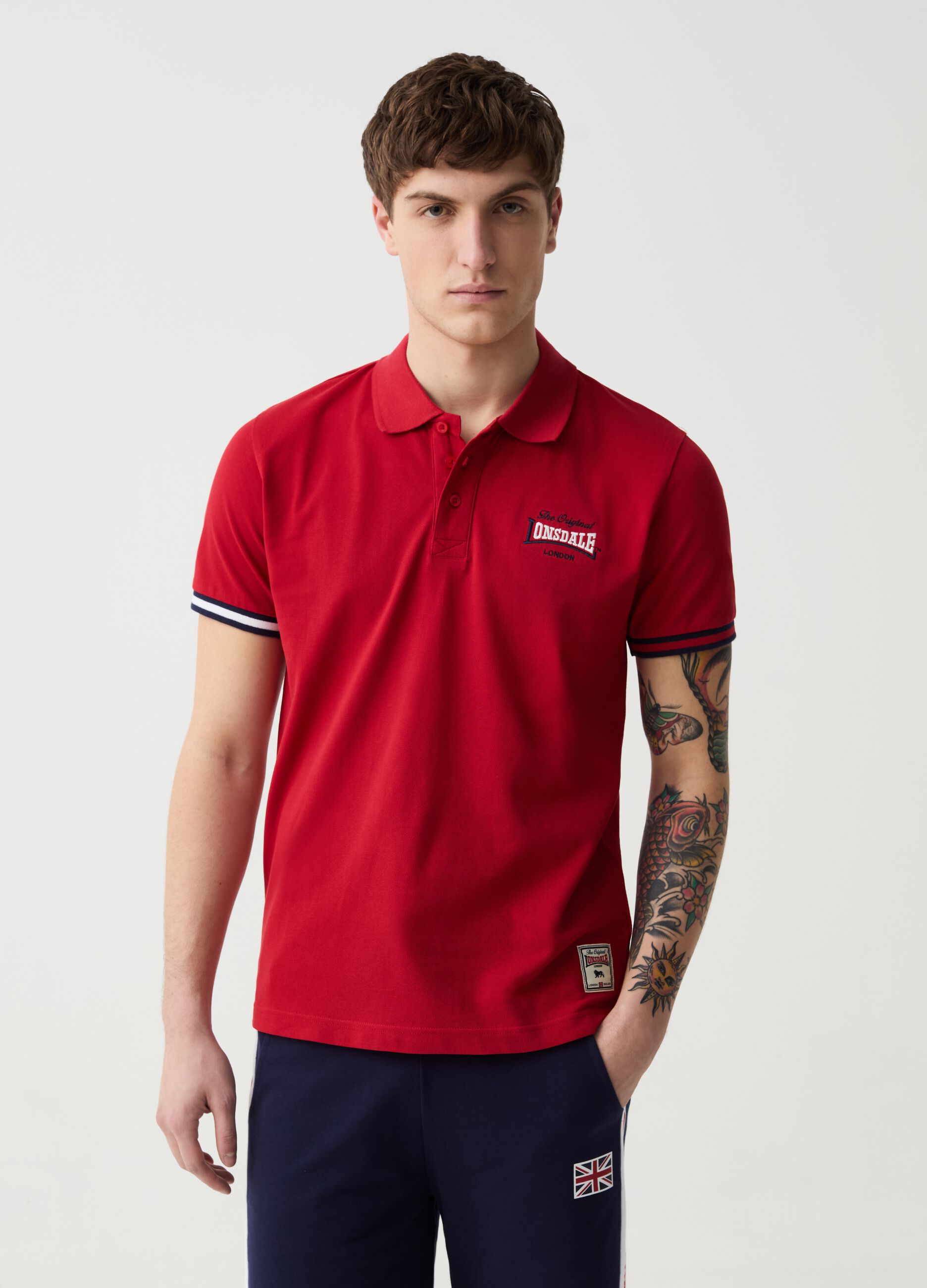 Polo shirt with striped edging and logo embroidery