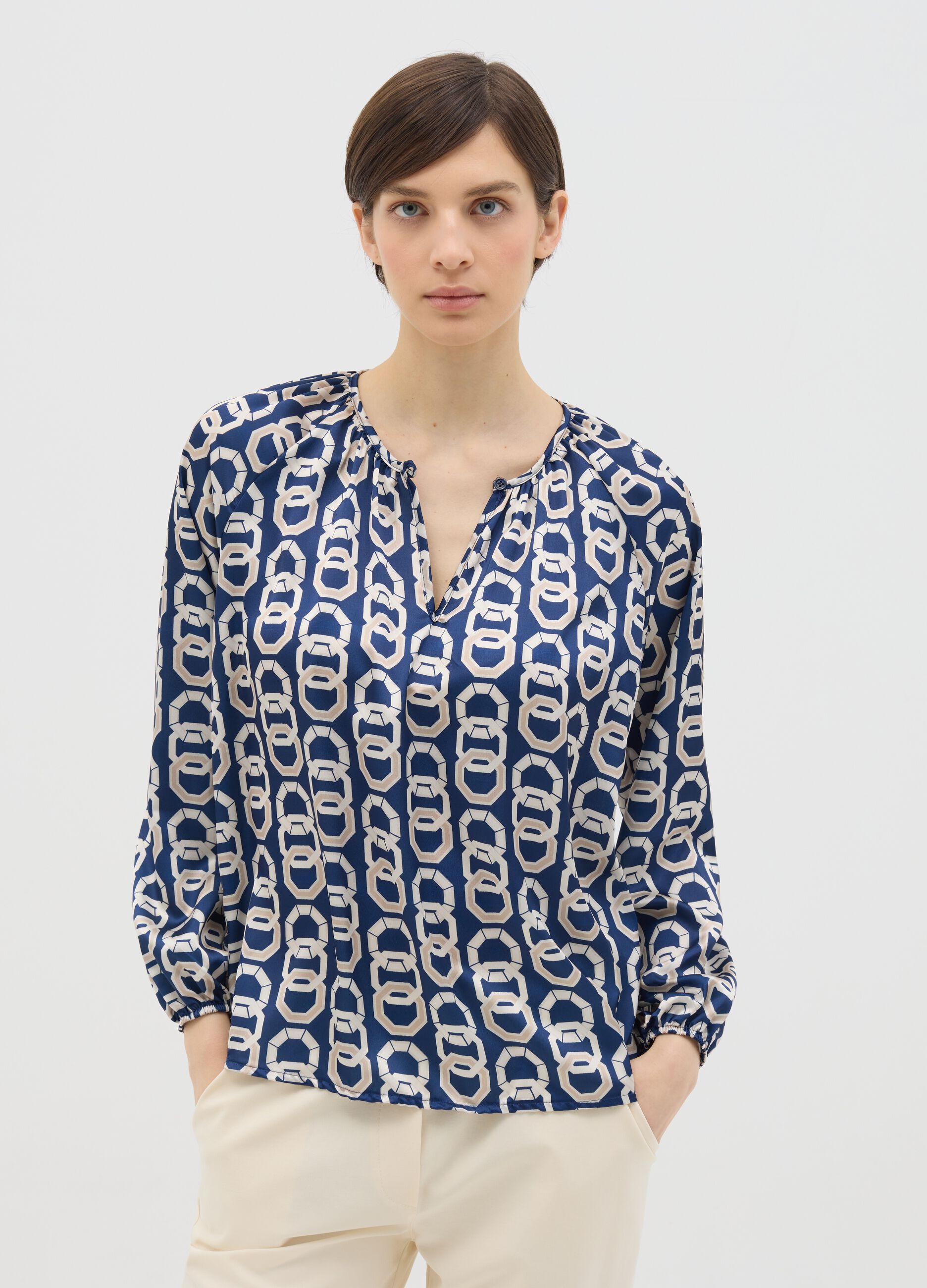 Blue long-sleeved blouse with geometric print