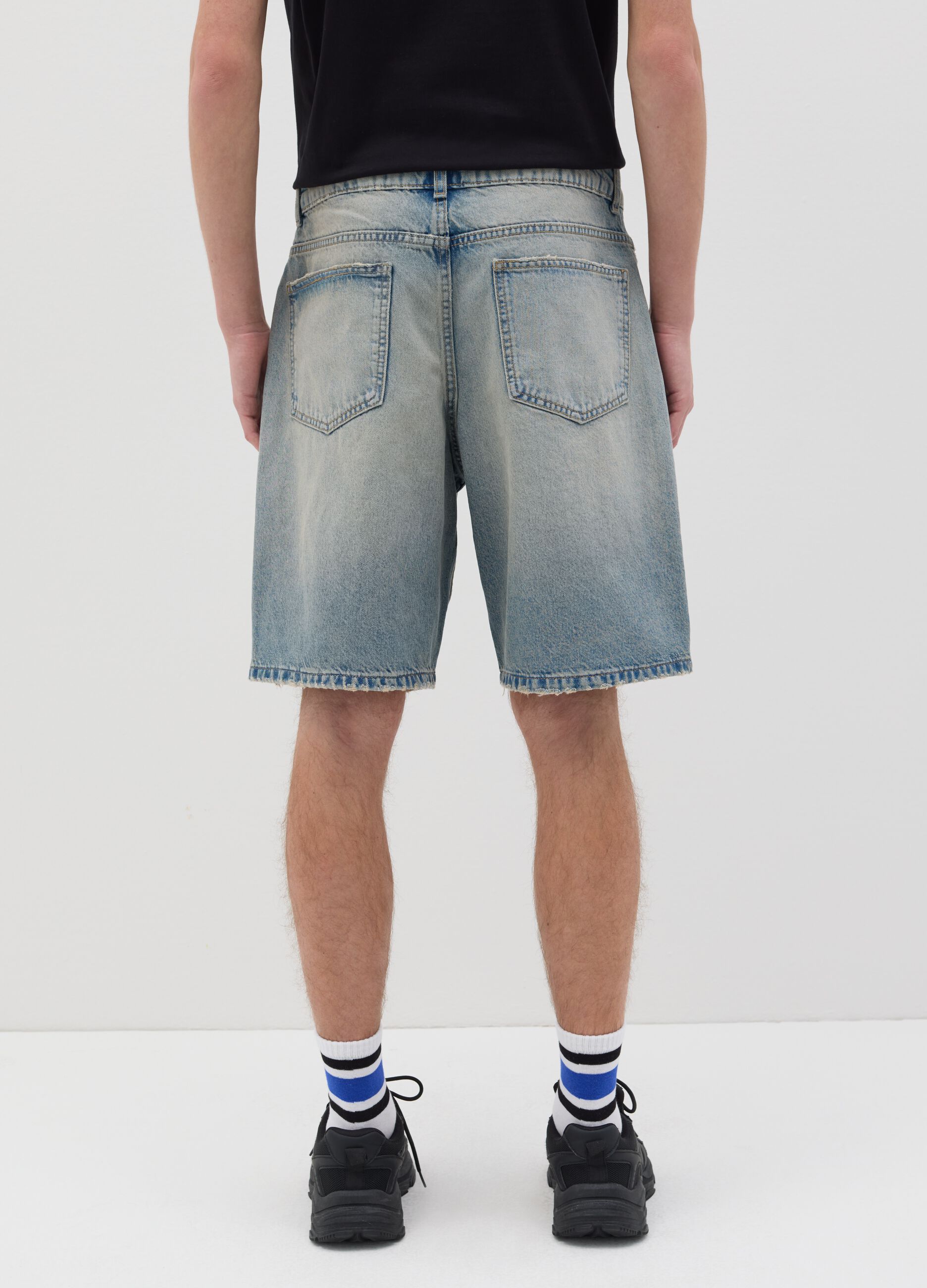 Light blue denim shorts with ripped details