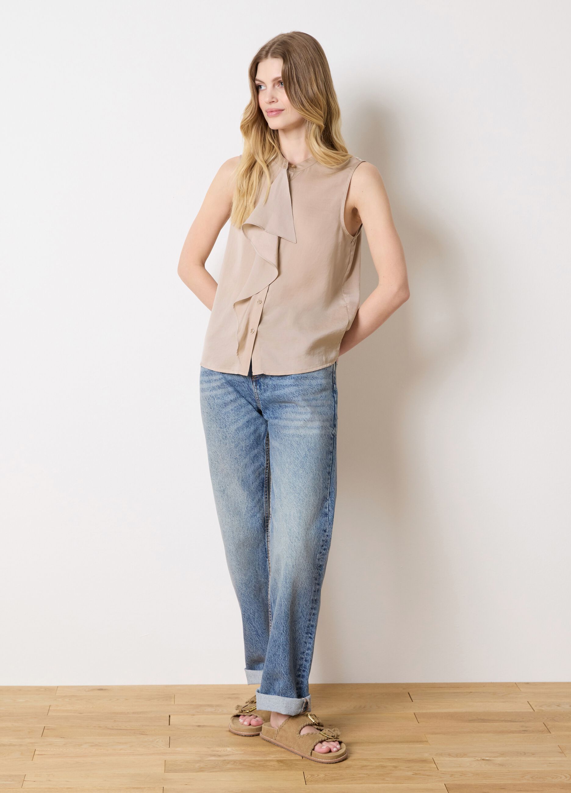 Beige sleeveless blouse with flounce