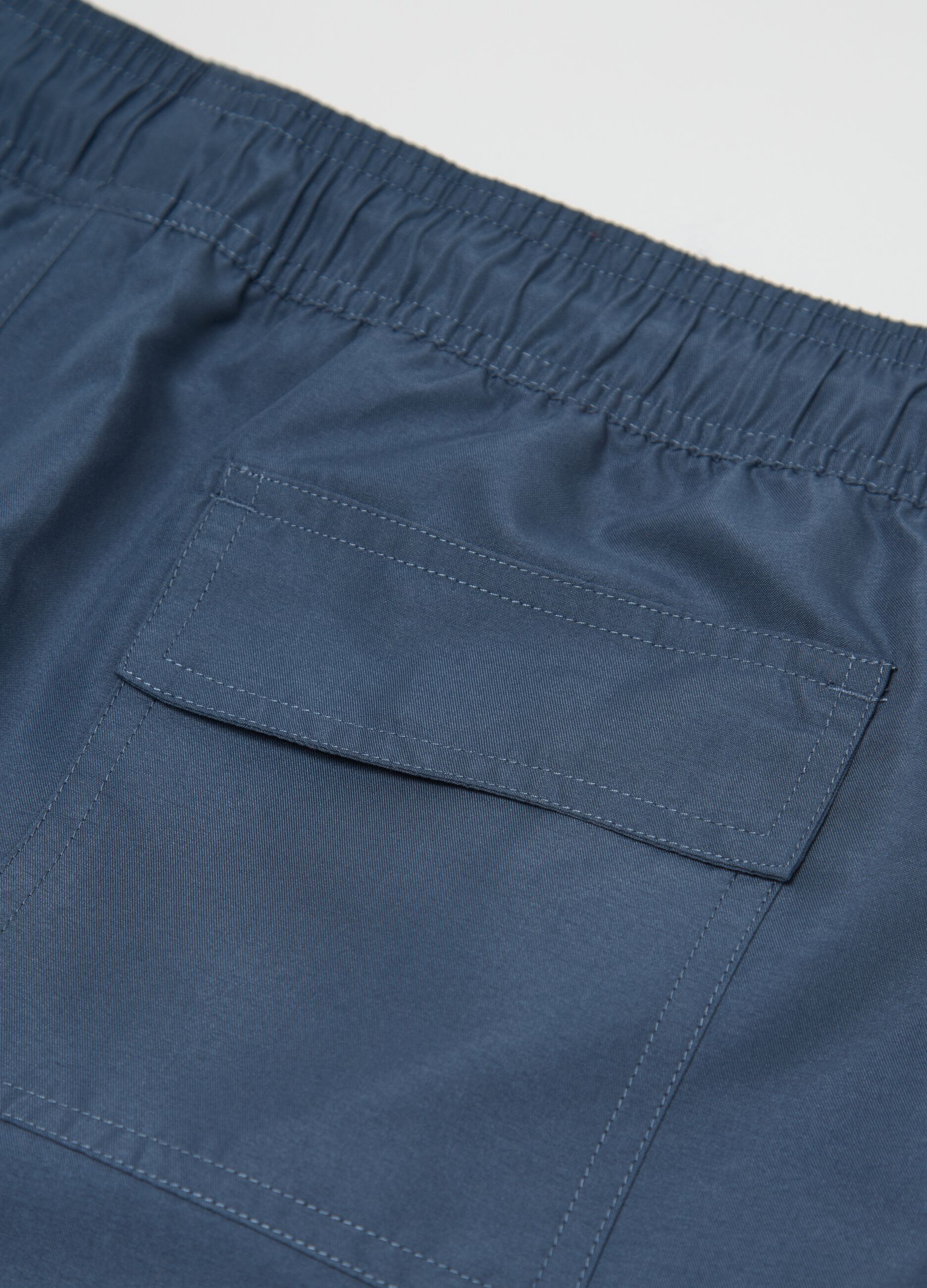 Blue swimming trunks with logo print