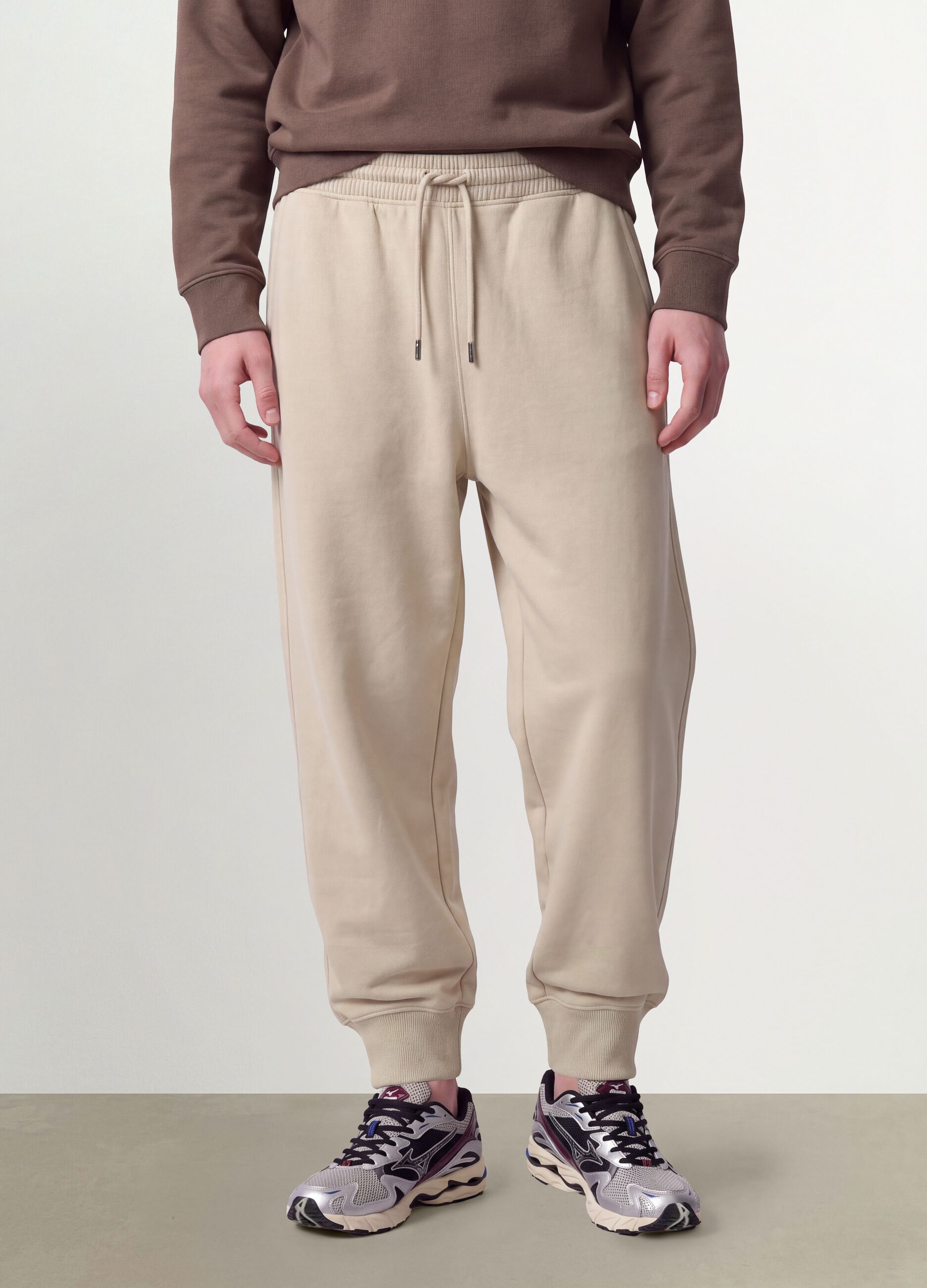 Beige cotton-blend joggers with cuffed hems and drawstring