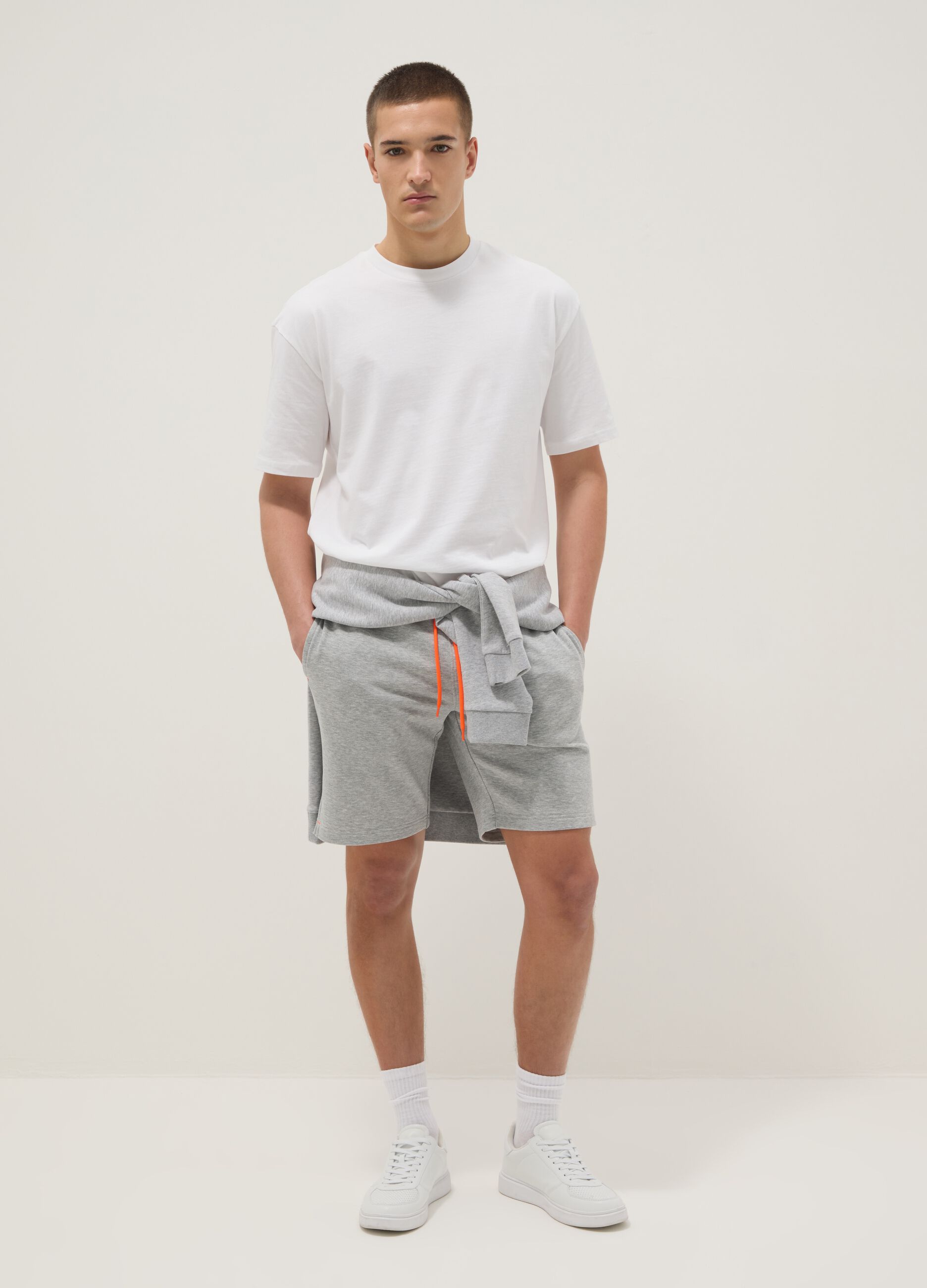 Grey shorts with orange drawstring