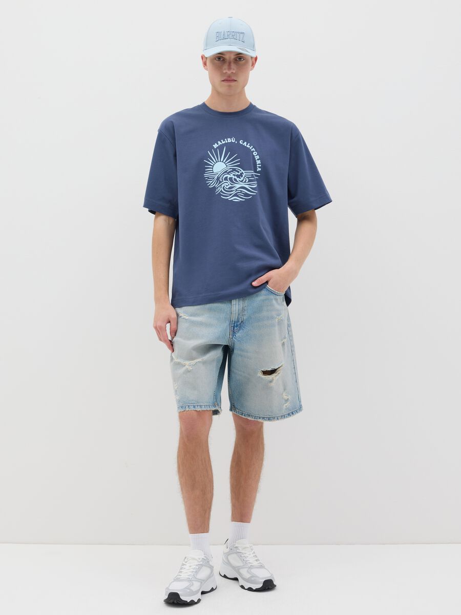 Blue denim shorts with ripped details_0