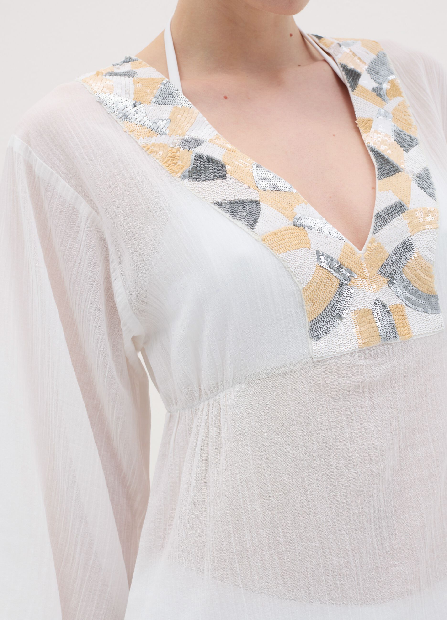 White beach cover-up with decorative edging