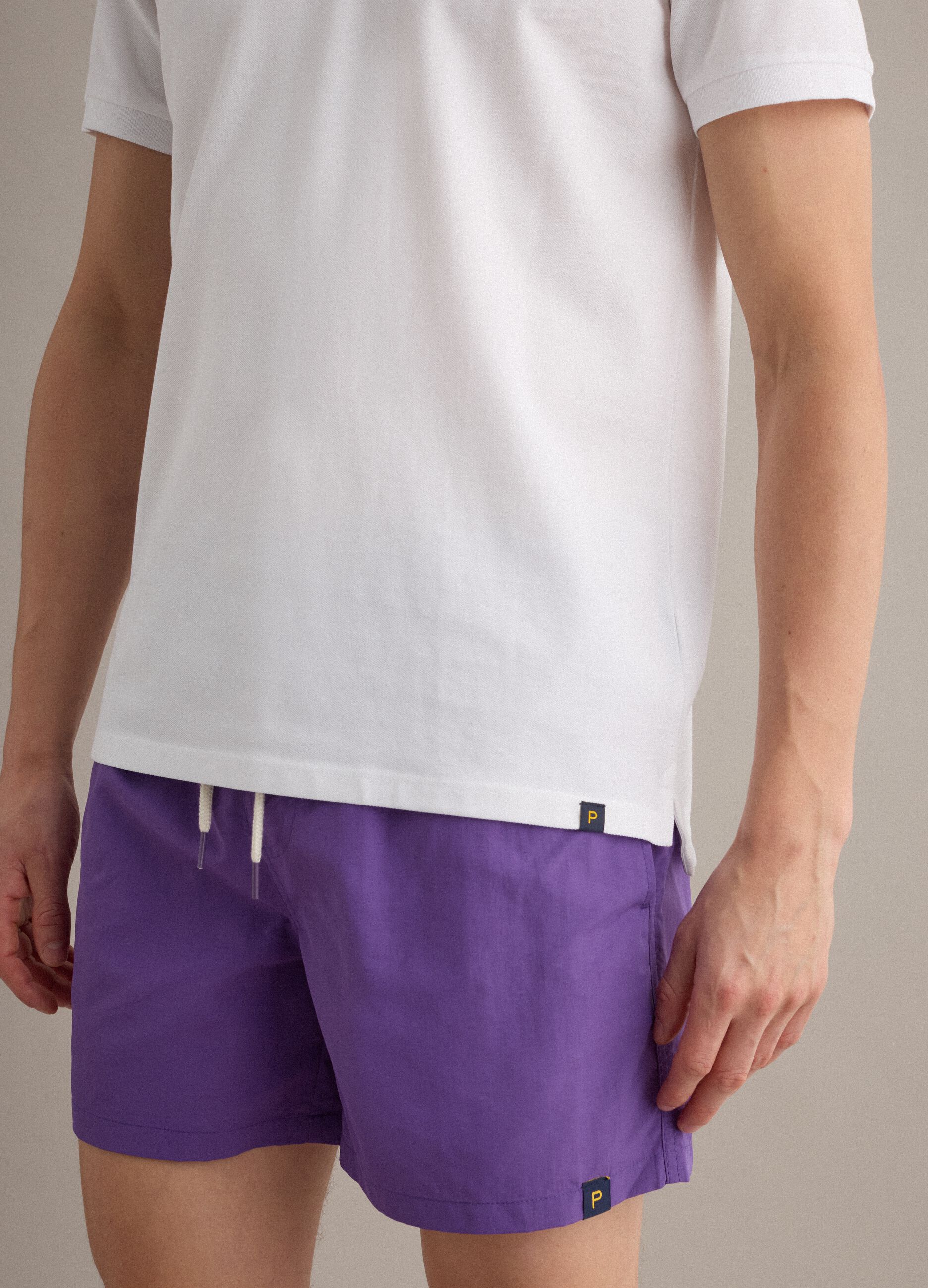 Purple swim shorts with elasticated waistband and drawstring